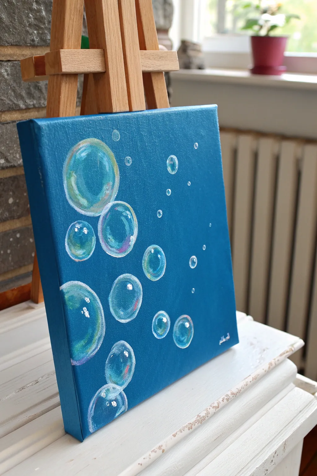 Easy undersea motion: minimalist bubble cluster trails rising on a bold blue ocean background.