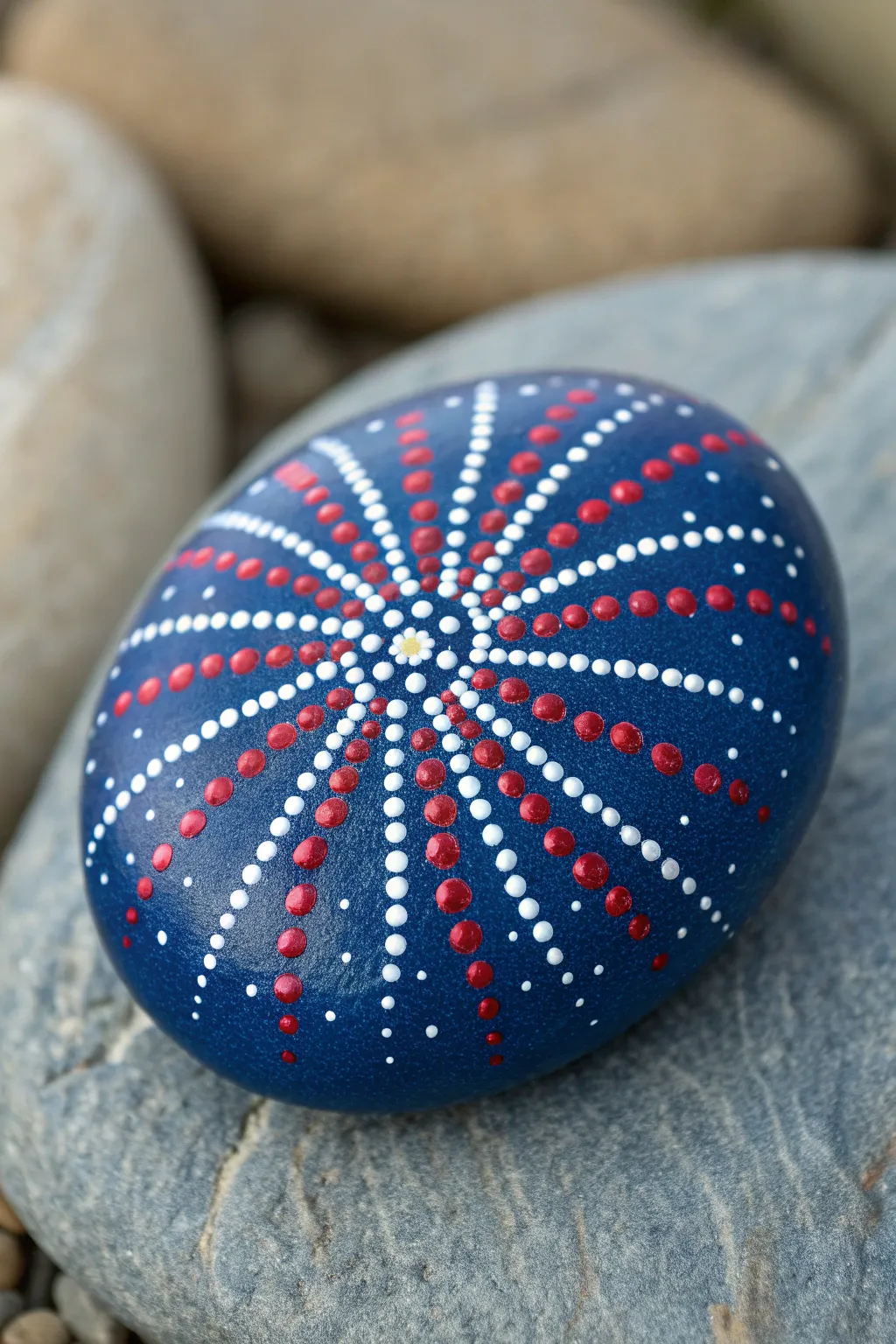 Midnight-blue rock with red, white, and blue dot fireworks, crisp contrast and artisan texture.