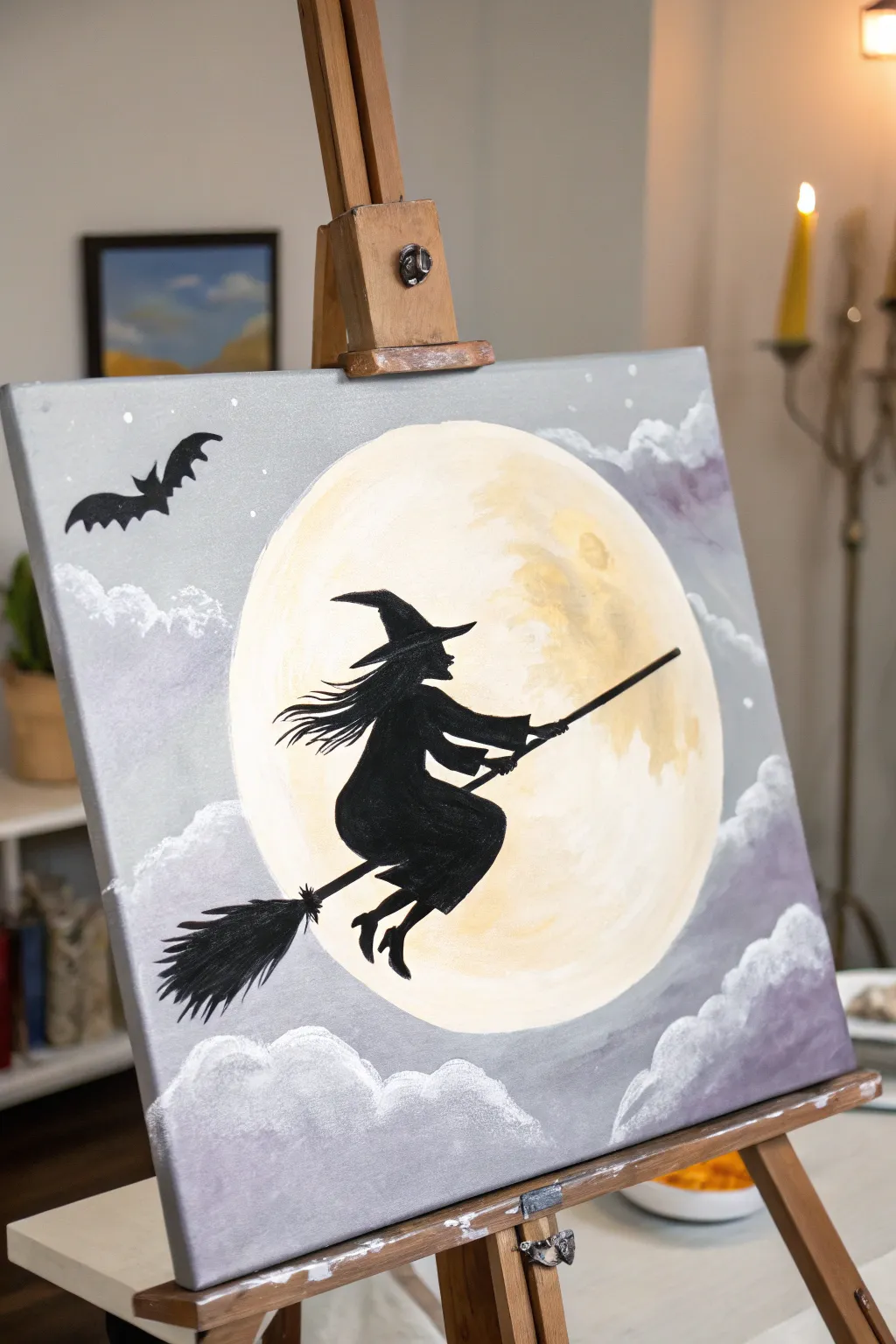 Crisp black witch silhouette crossing a glowing moon with softly blended clouds