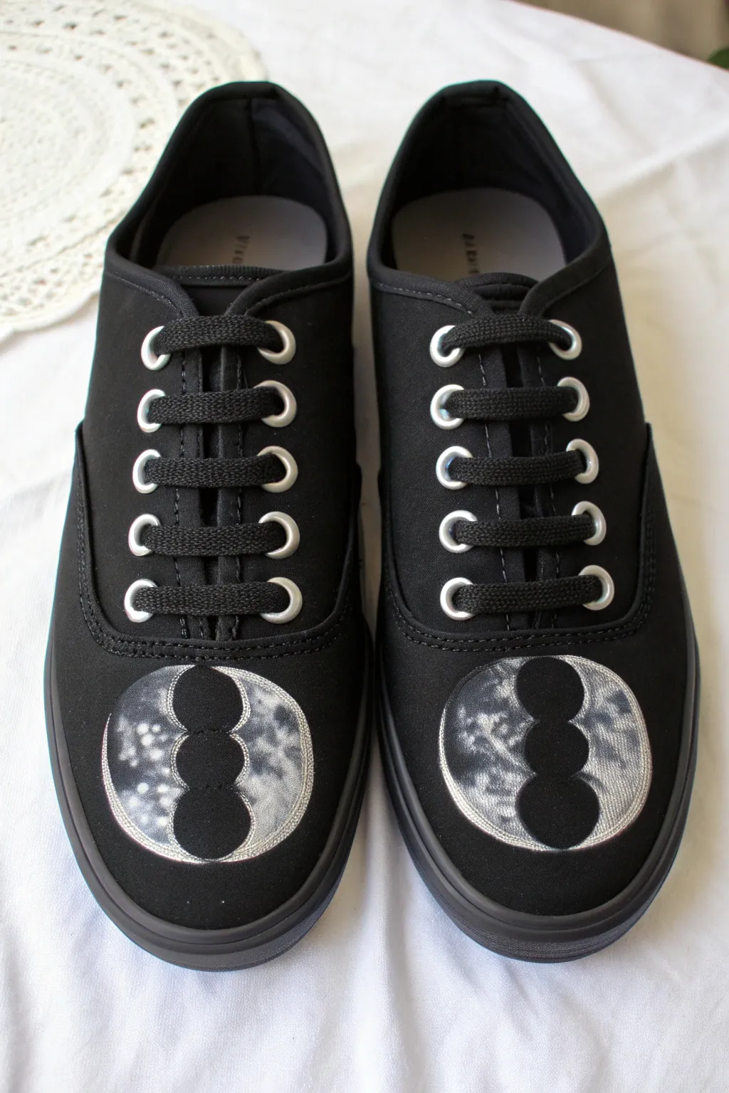 Minimal black sneakers with pale moon phases, a crisp celestial accent for DIY painters