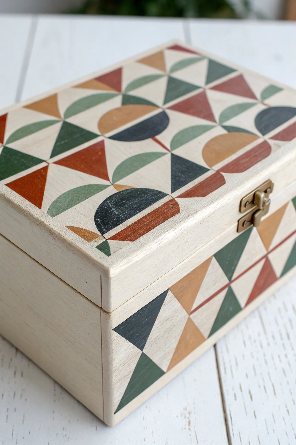 Modern geometric box painting: crisp triangles and arches wrapping cleanly around each corner