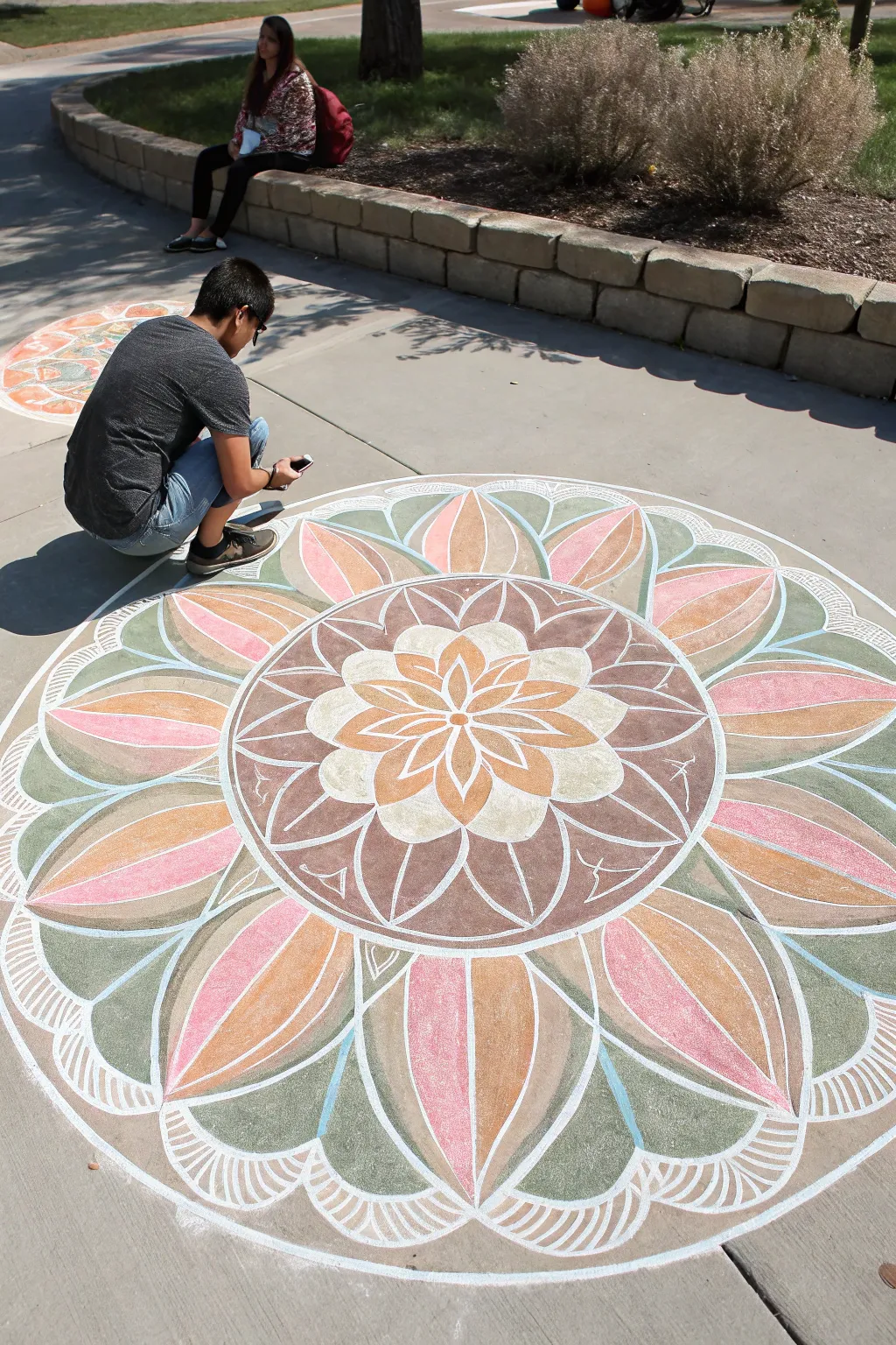 Soft boho flower mandala chalk medallion, perfectly centered on concrete for an easy sidewalk statement.