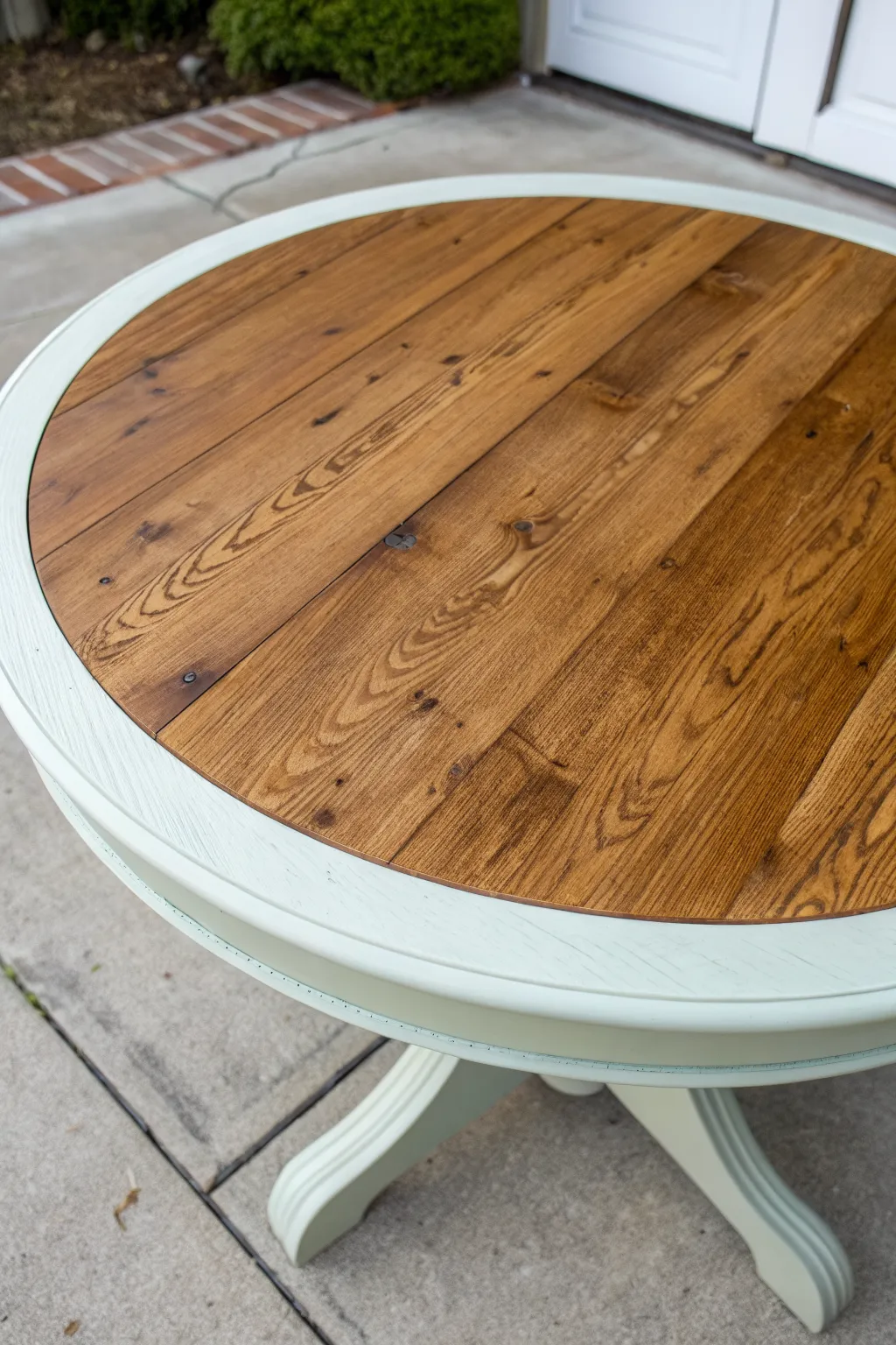 Two-tone tabletop idea: warm wood grain center with a calm matte painted border for contrast