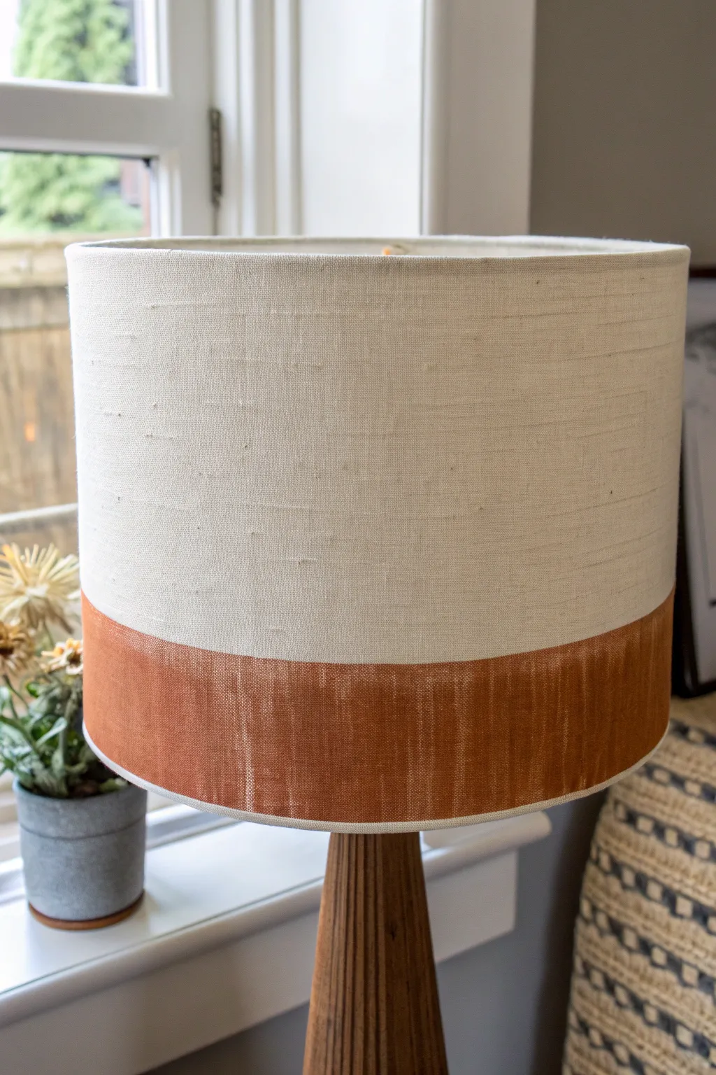 Graphic two-tone dipped edge lampshade in warm white linen and muted terracotta