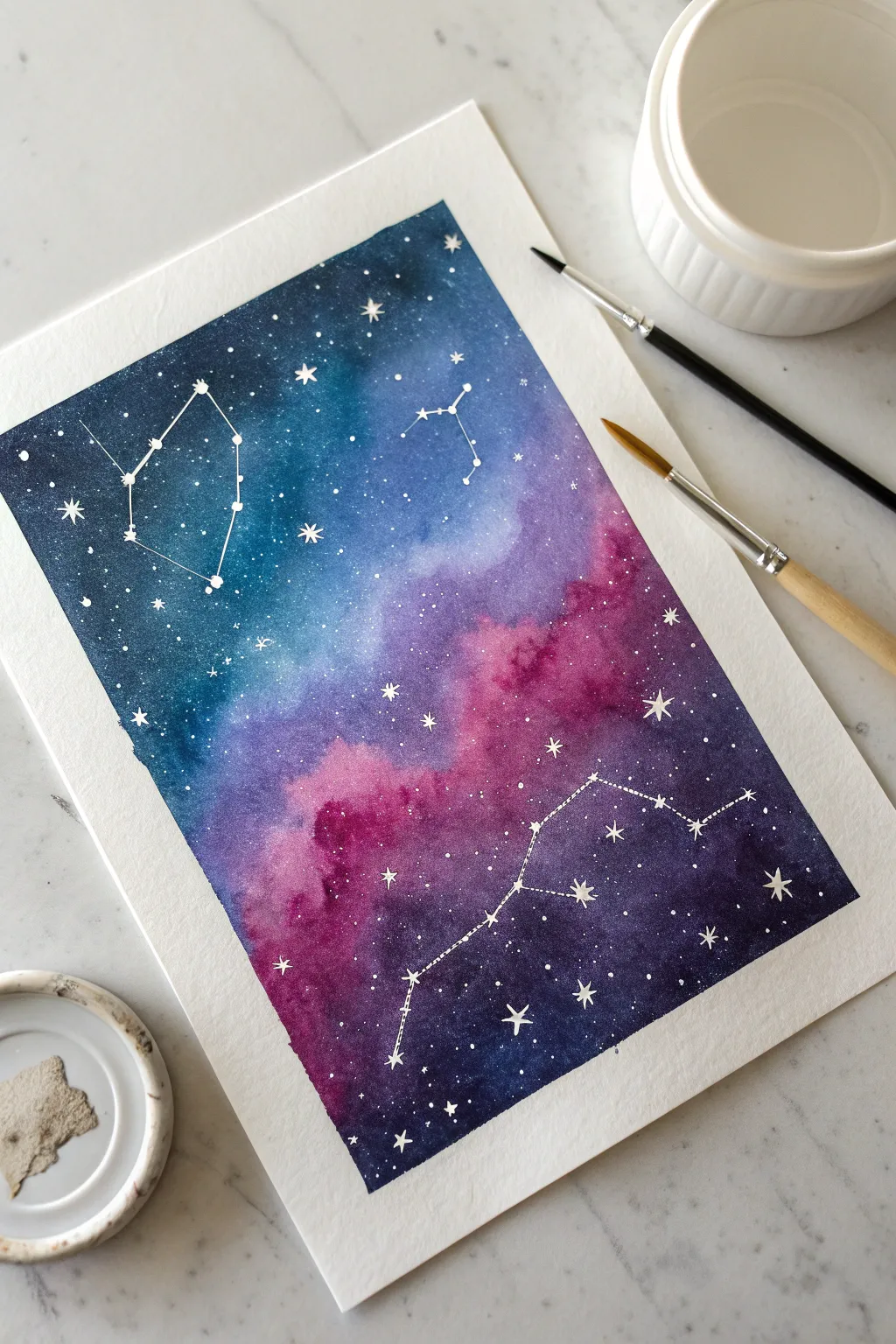 Dreamy galaxy wash with toothbrush star splatter and bright clustered constellations