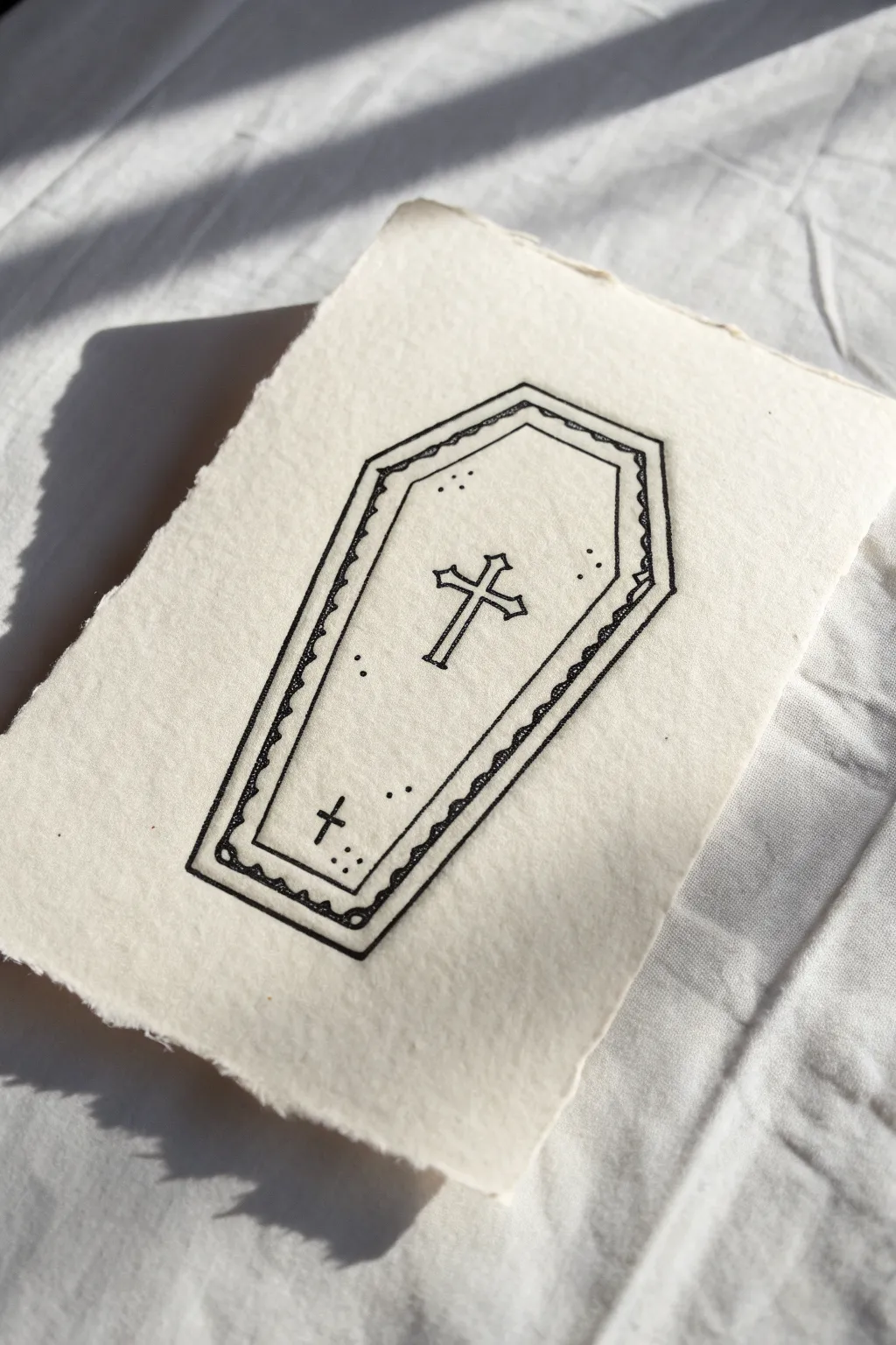 Simple gothic coffin outline with tiny cross and rivet dots, crisp black ink on warm paper