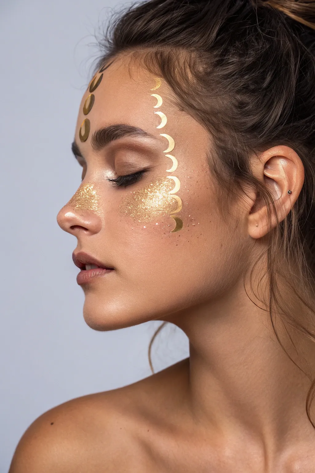 Channel your inner moon witch with this minimalist celestial gold face paint design.