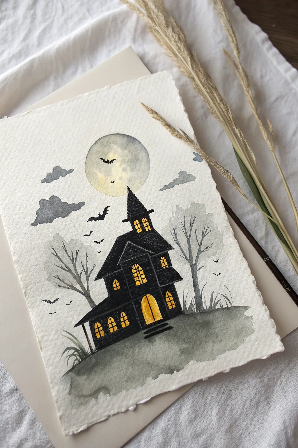 Minimal haunted house painting with glowing windows and soft fog for a chic Halloween mood