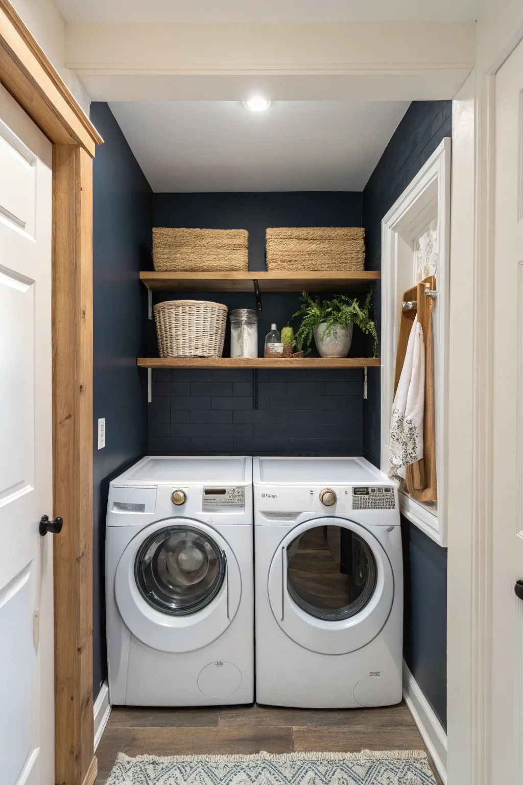 A navy accent wall adds depth and drama while keeping the laundry room light and serene.