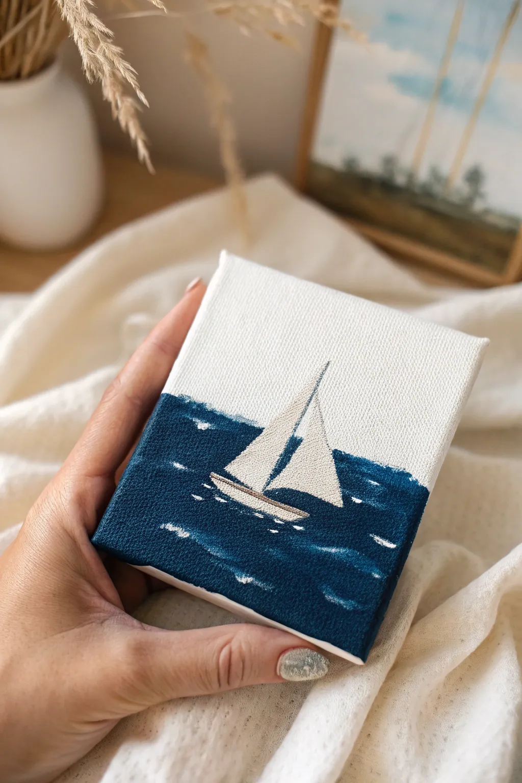 Capture the calm of the ocean with this simple and elegant mini sailboat painting idea.