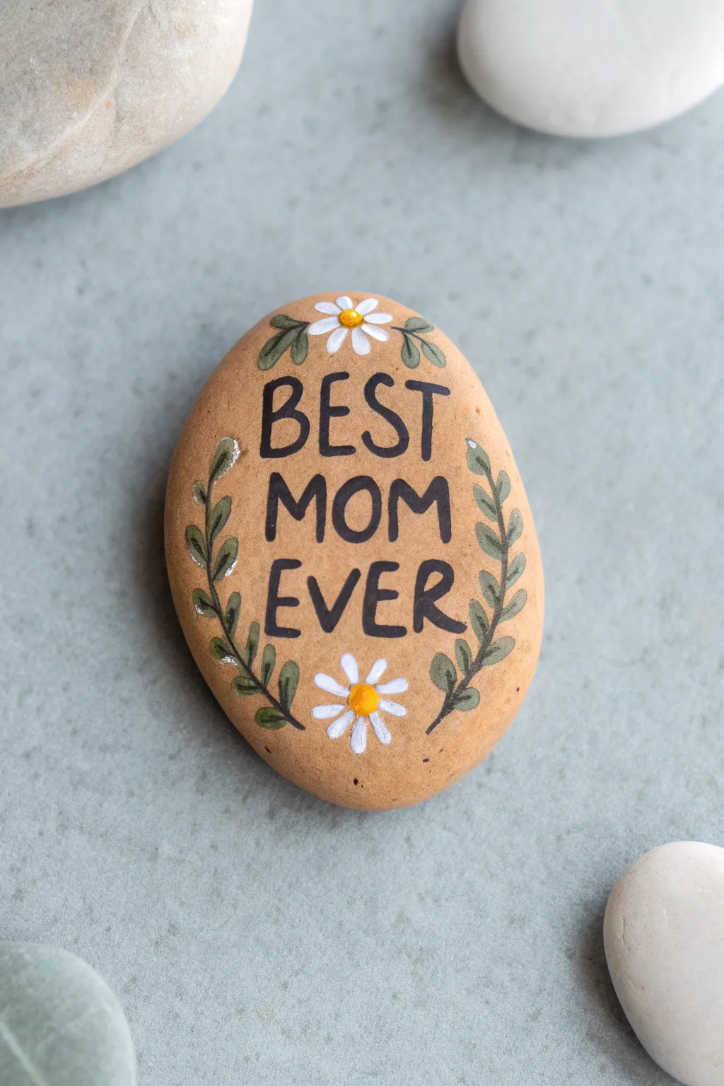 Paint a daisy border Mothers Day rock with Best Mom Ever at the center for a sweet handmade gift