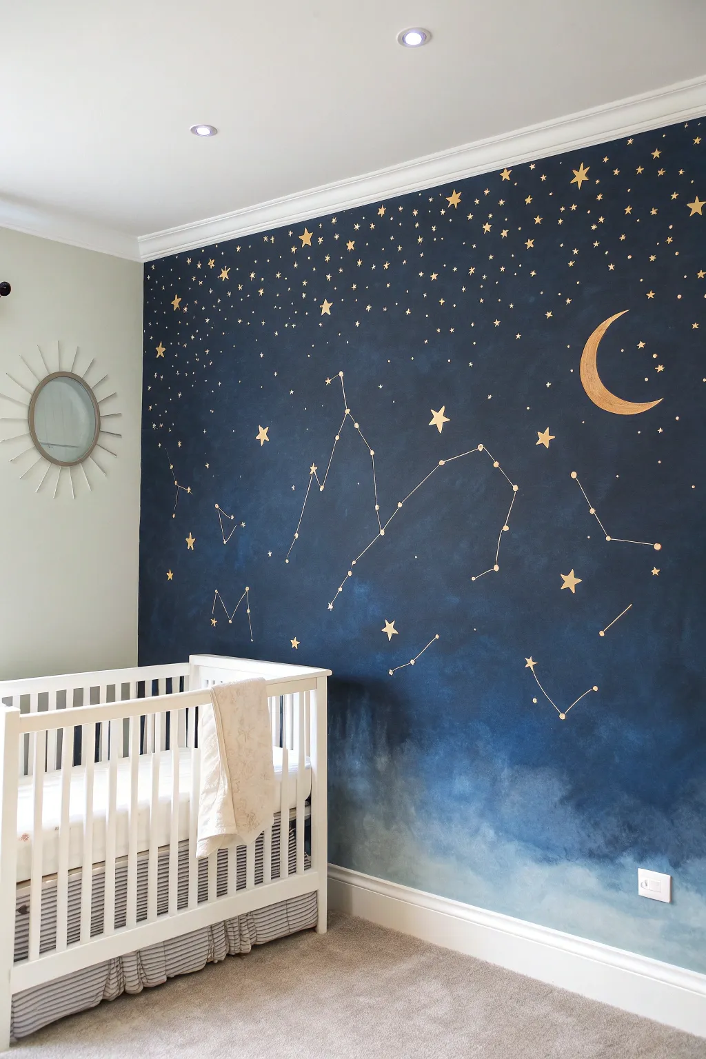 Deep indigo starry mural with a soft moon and constellations for a calm, cozy nursery