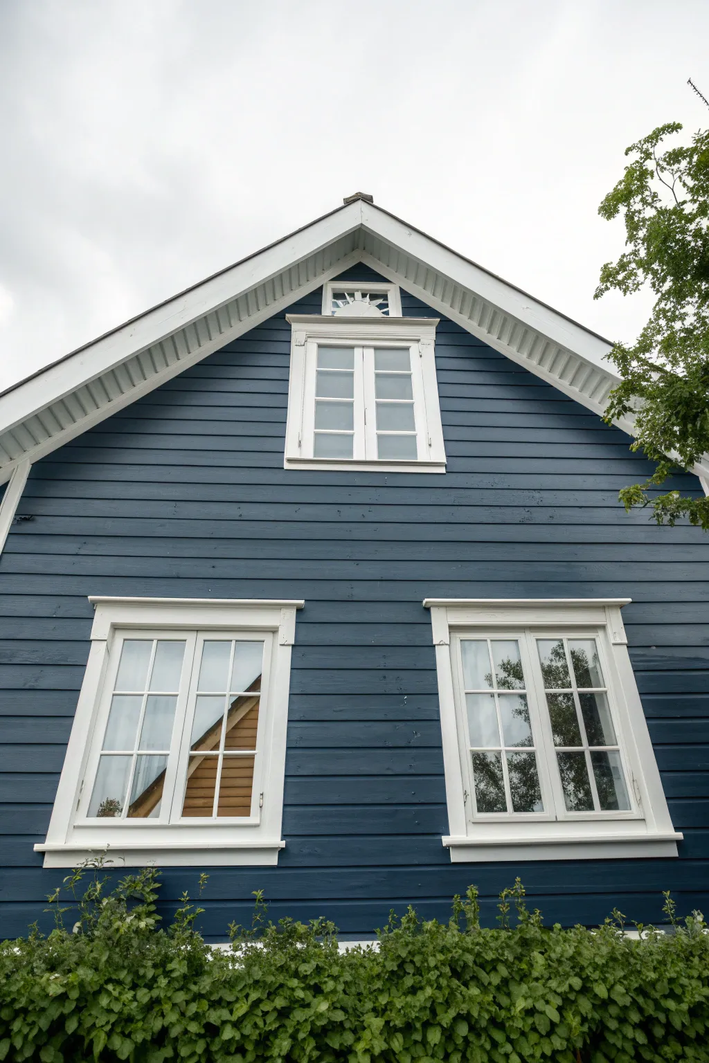 Deep navy siding with crisp white trim, perfect contrast for outdoor painting inspiration