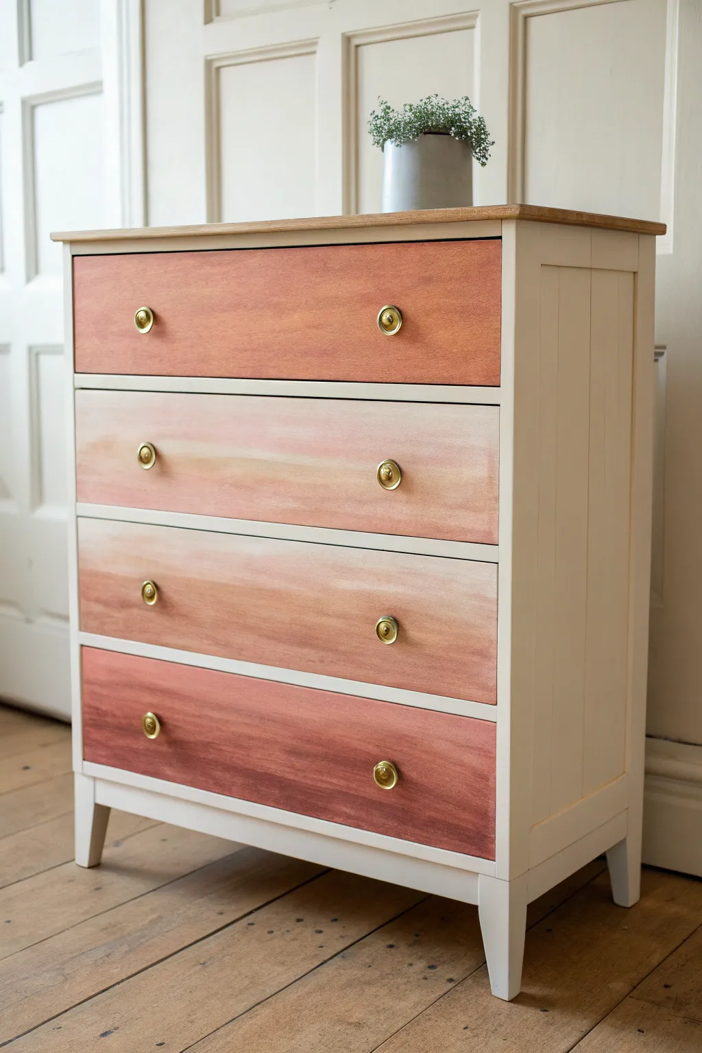 Ombre chest of drawers fading from deep terracotta to airy blush for calm, handcrafted style