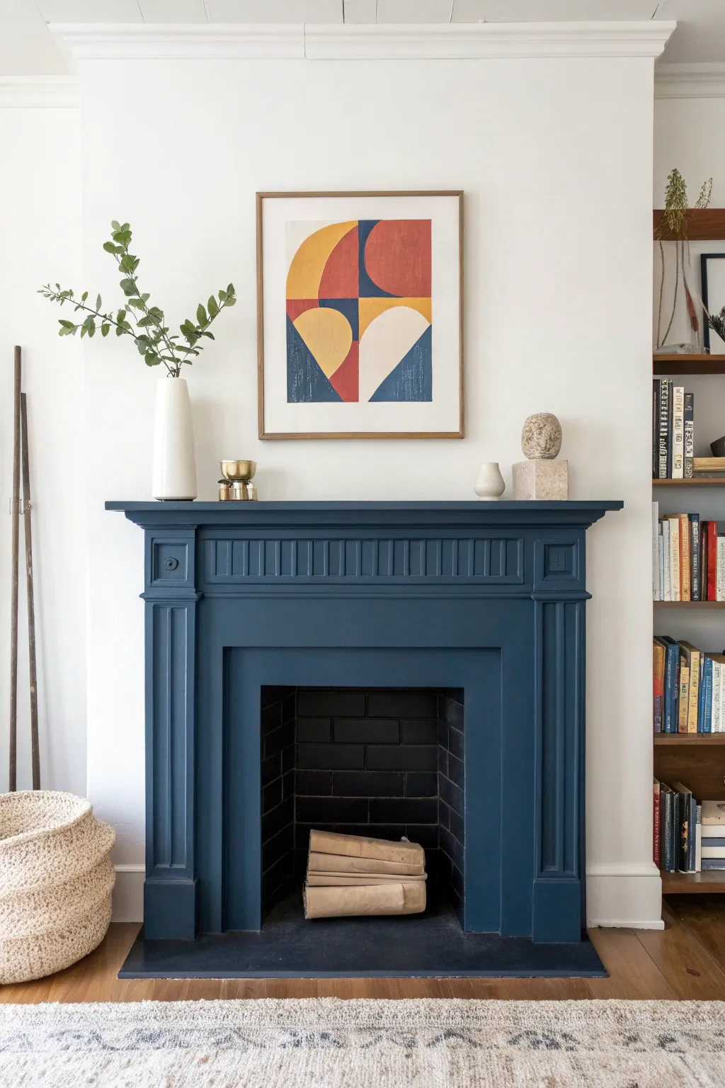 Navy mantel styling: a tailored anchor tone with a bright print and a simple stack of books.