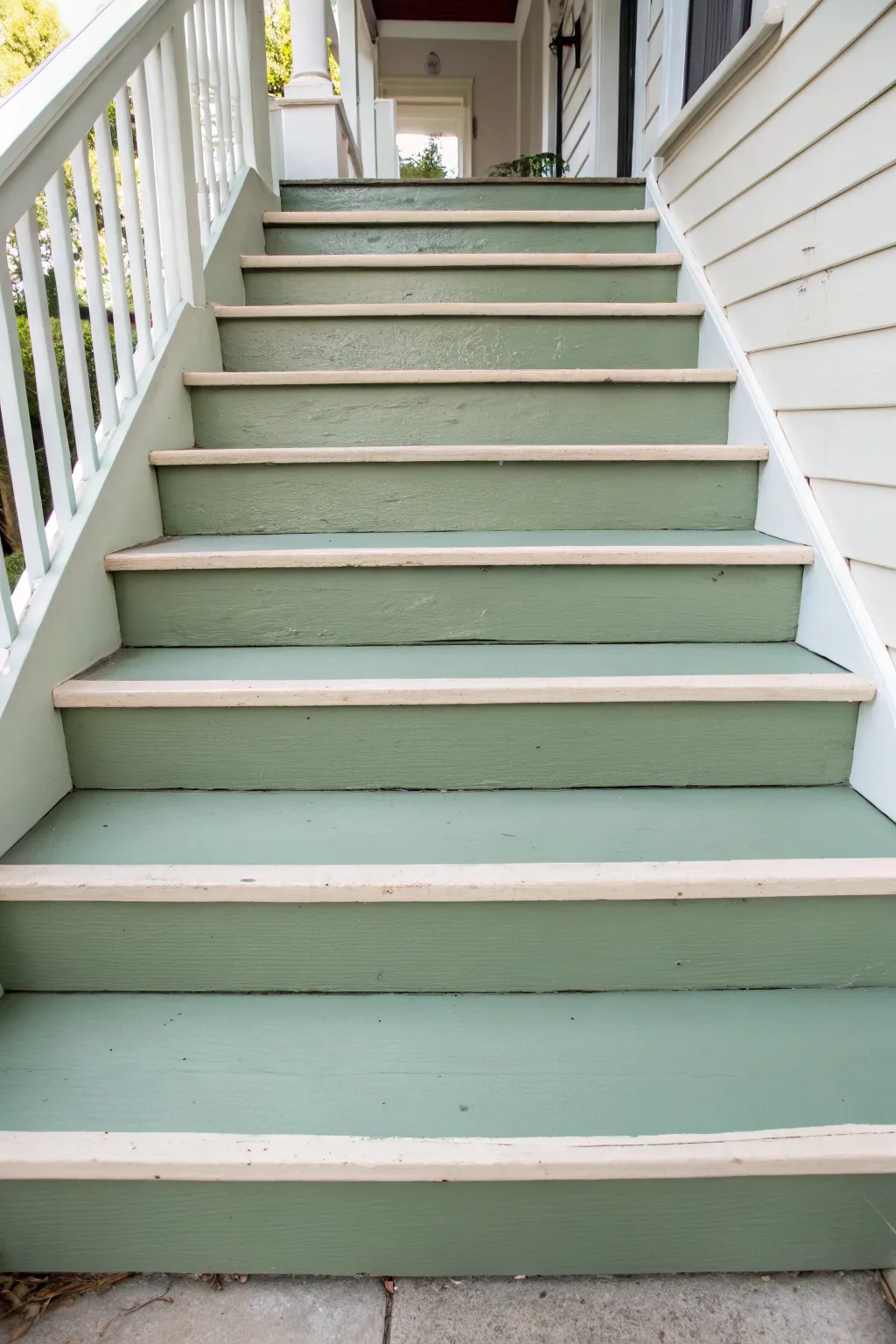 Muted sage porch steps with creamy edge highlights for simple, safe, Scandinavian style curb appeal
