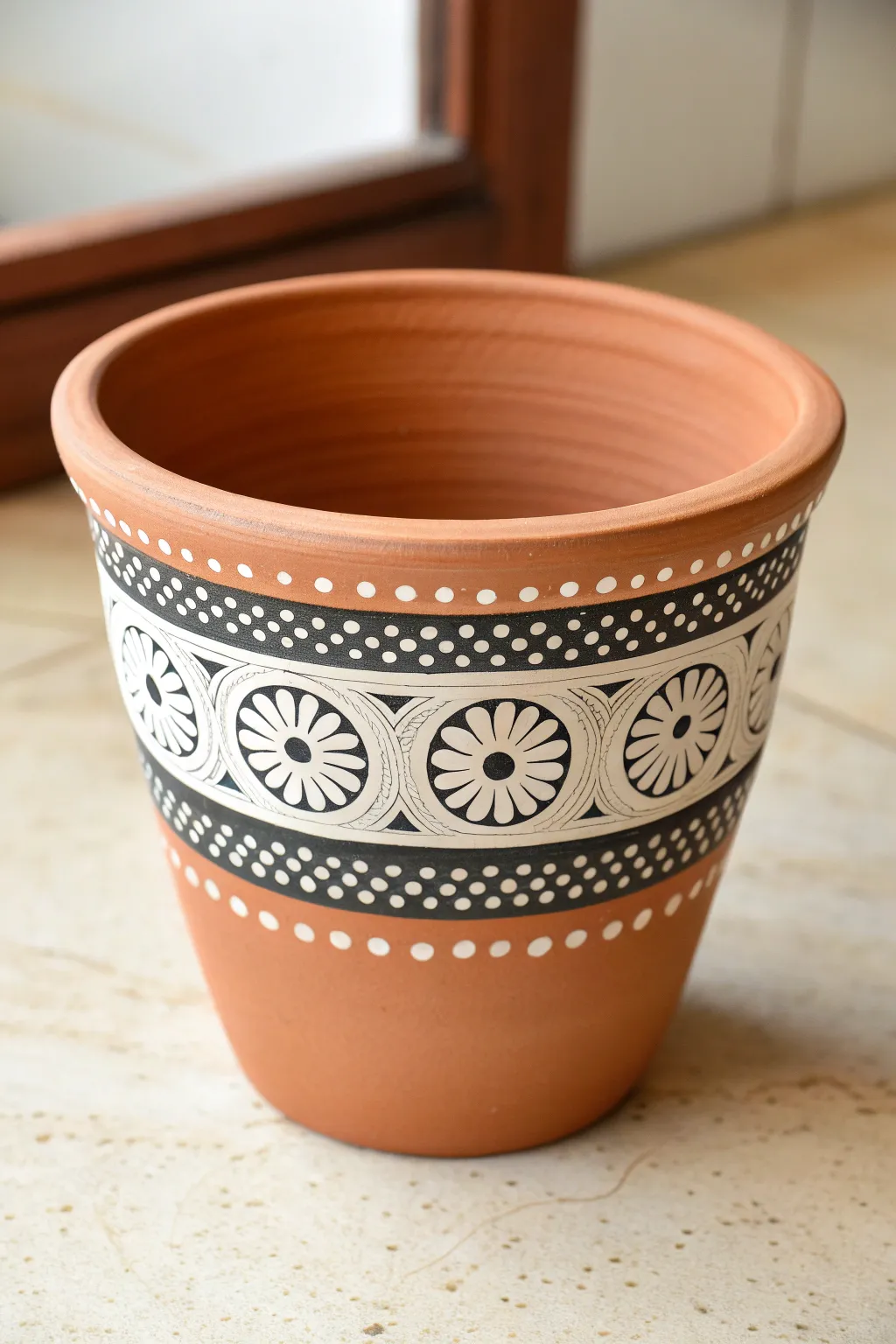 Mandala dot bands on a terracotta pot, a minimalist boho idea with clean contrast and rhythm