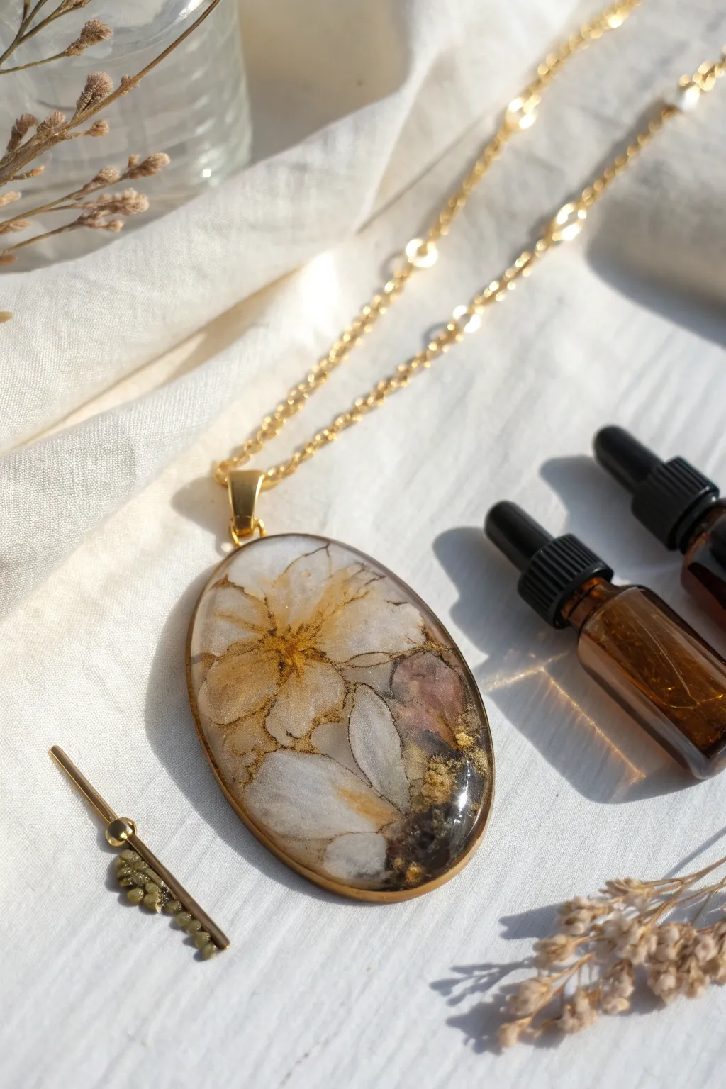 Smoky alcohol ink swirls captured in a glossy resin pendant, minimalist boho studio mood.