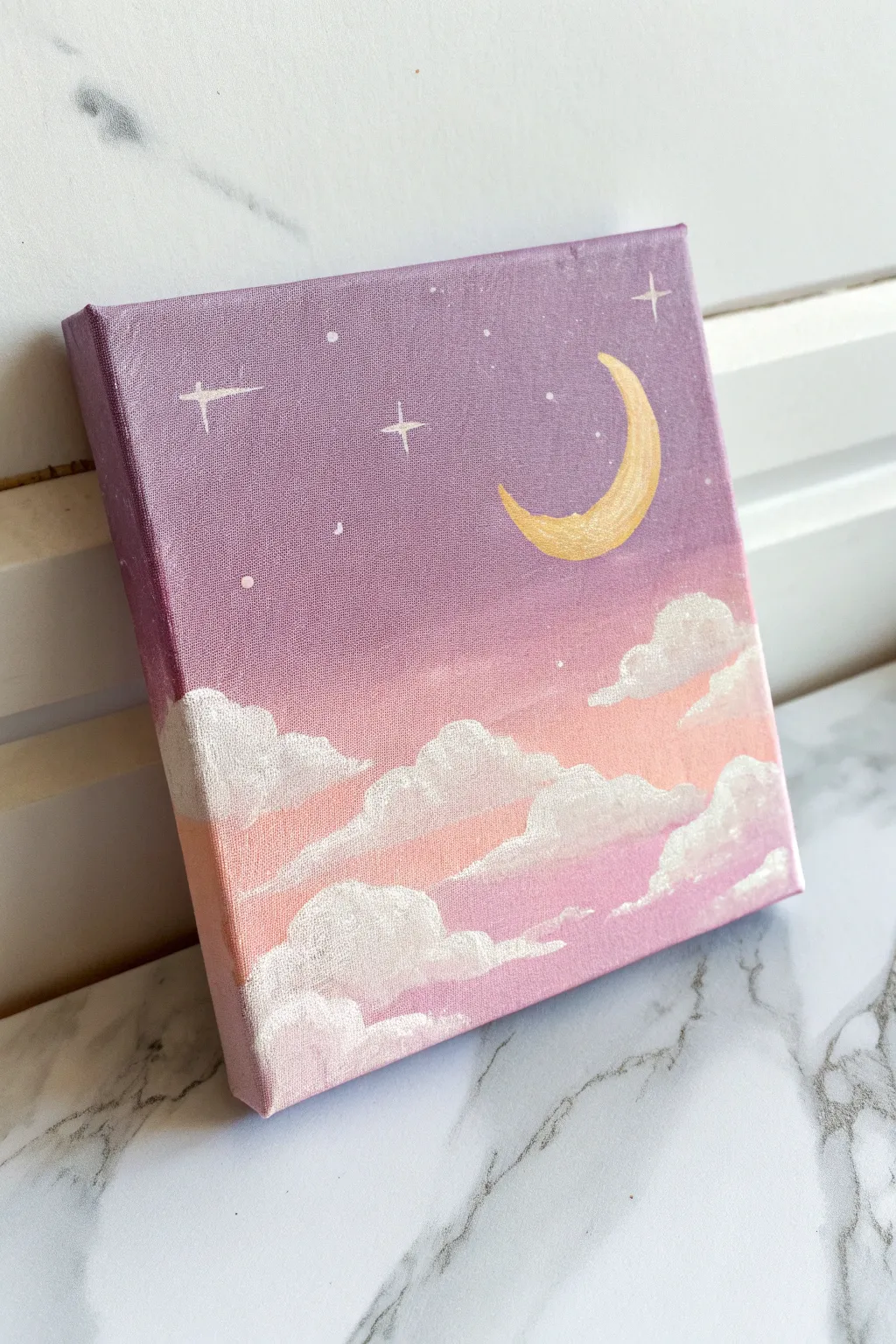 Beginner small canvas idea: a crisp crescent moon floating above soft, dreamy pastel clouds