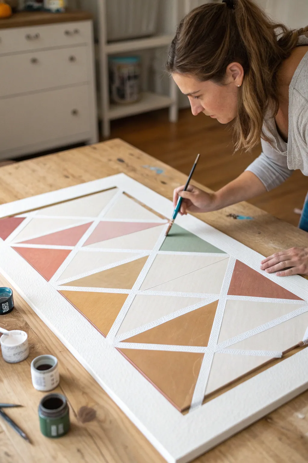 Crisp triangle color-blocks with painter’s tape for clean edges and satisfying brush-to-line detail.