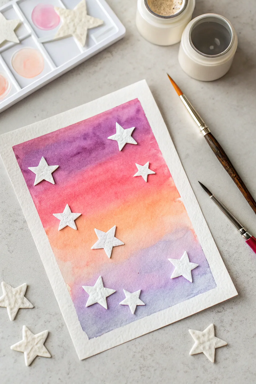 Reveal magical shapes! Peel stickers to show crisp stars against a dreamy sunset watercolor wash.