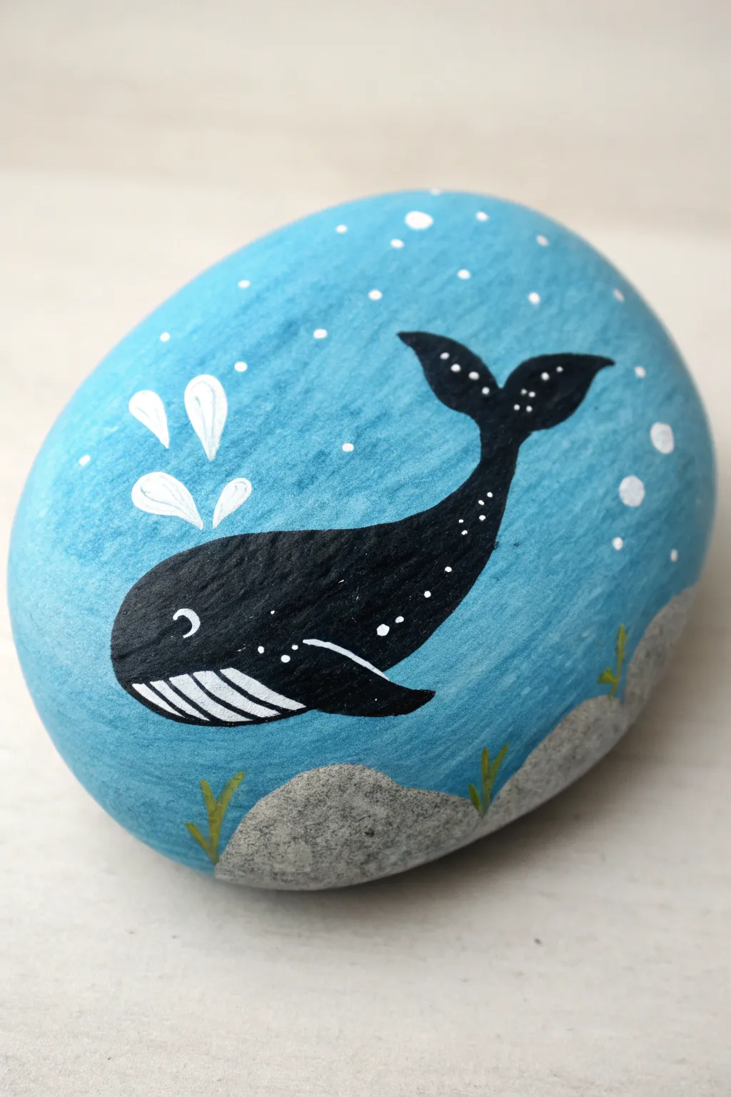 Minimalist whale silhouette on a blue gradient rock, clean bubbles and calming Nordic vibes.