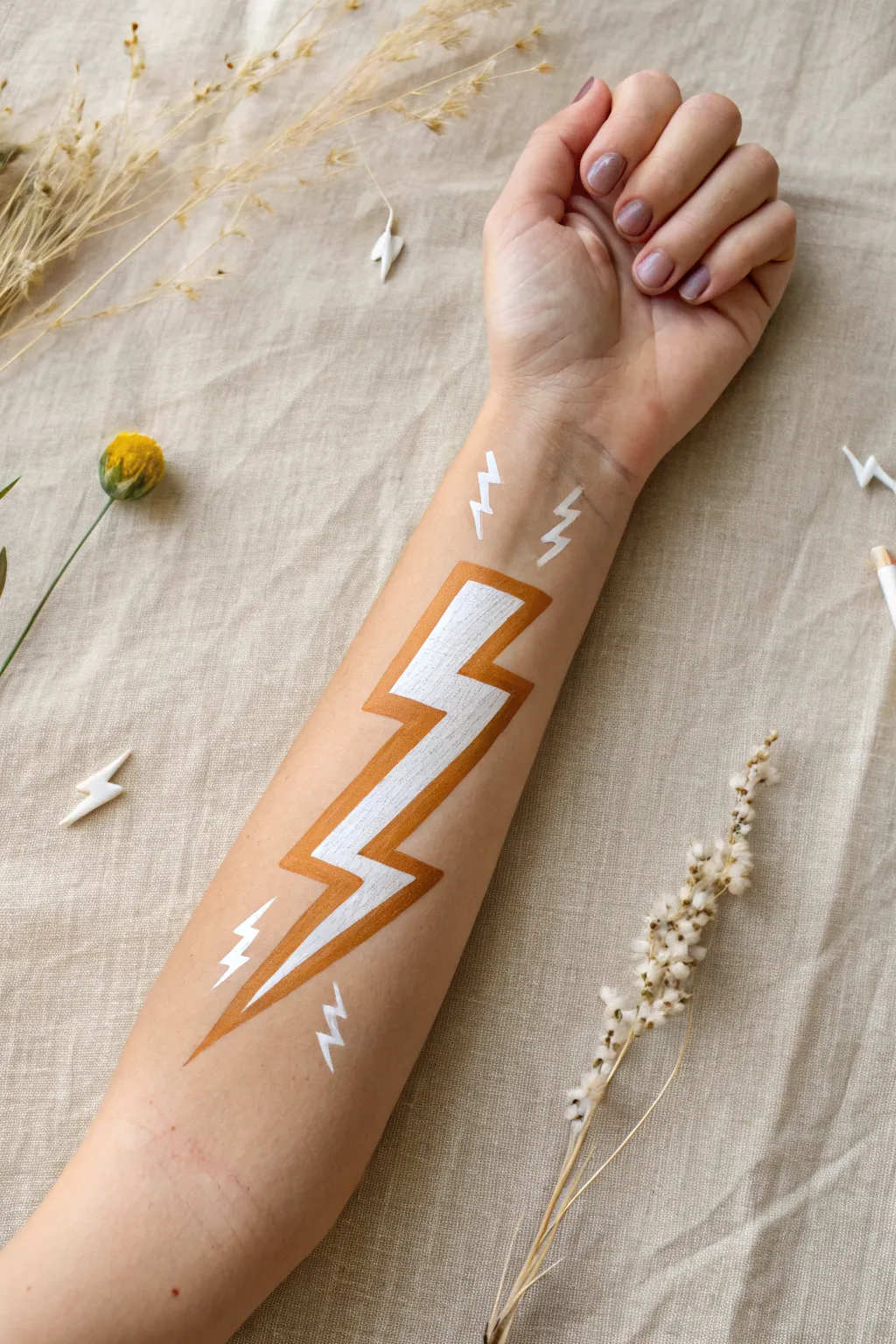 Easy arm painting idea: bold lightning bolt power stripe with clean contrast, minimalist boho style