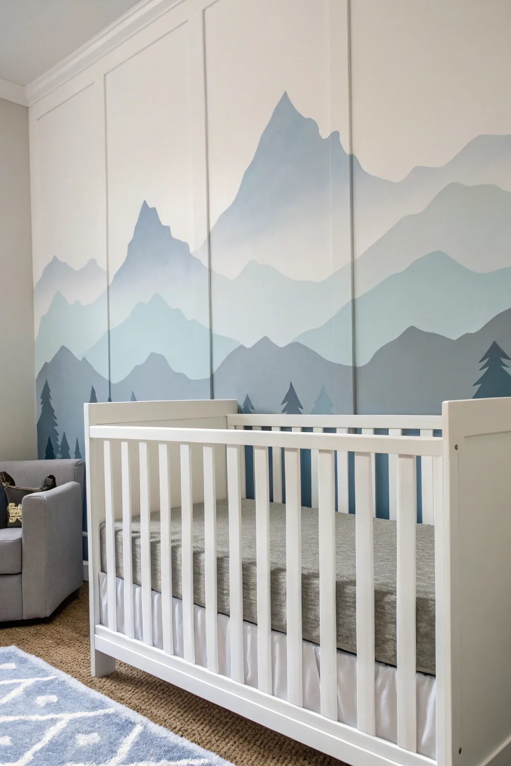 Calm minimalist mountain mural in dusty blue layers, perfect for a soothing nursery wall.