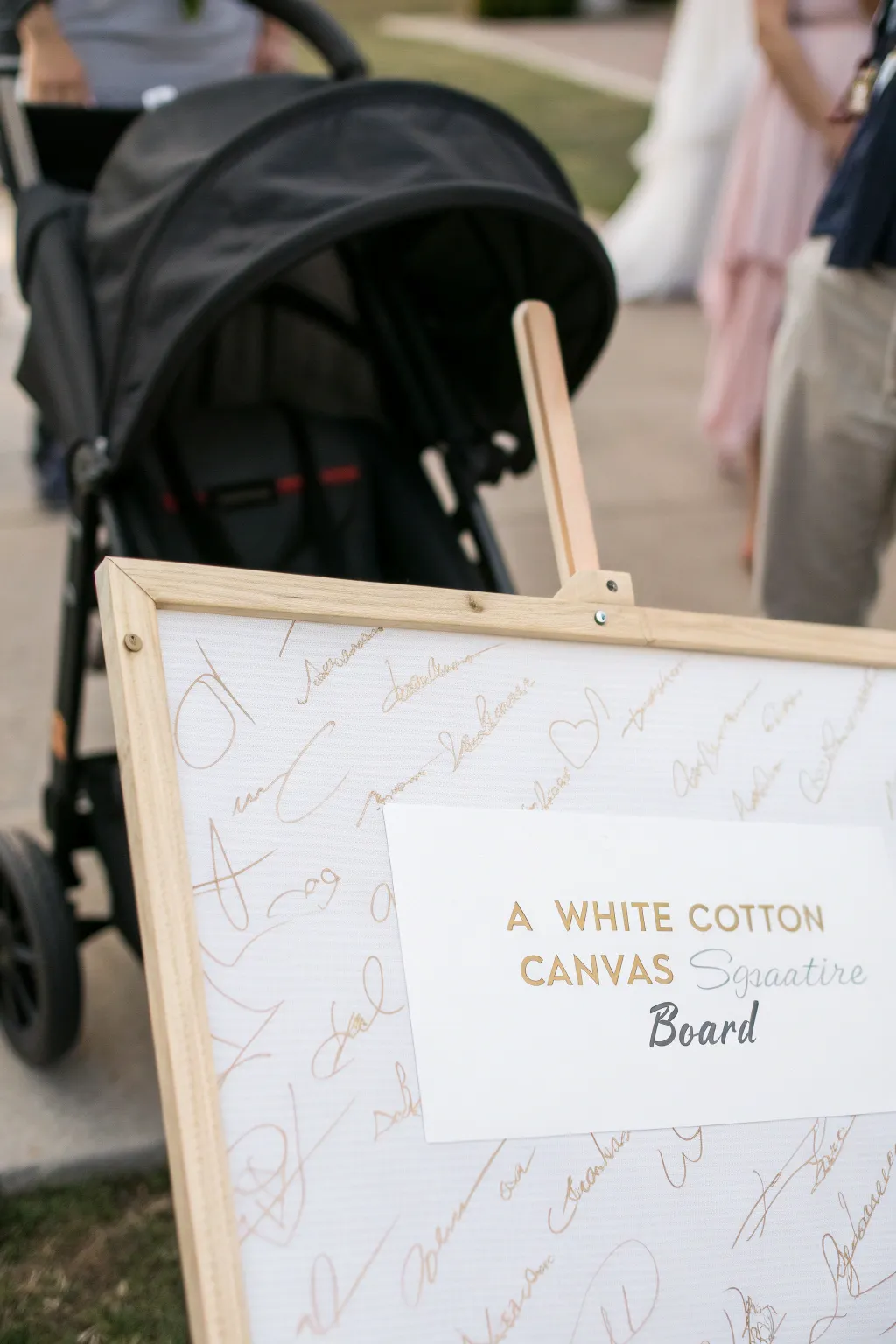 Minimal stroller silhouette canvas for guests to sign, a modern baby shower keepsake.