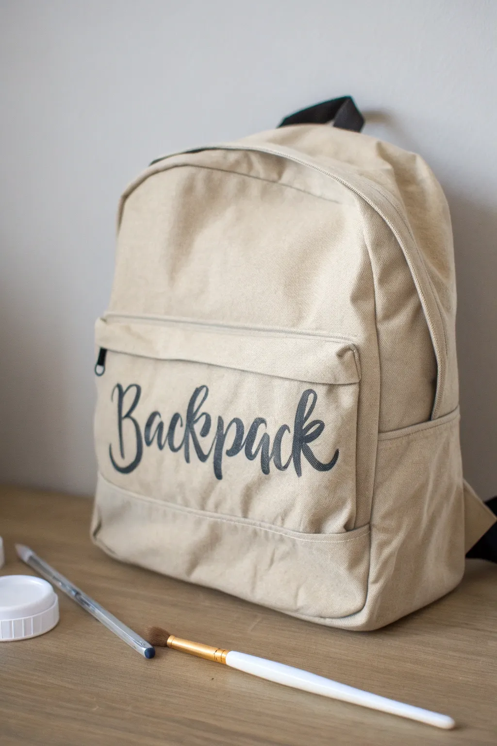 Minimal canvas backpack with pencil guides and fresh paint-pen lettering for mantra-style art
