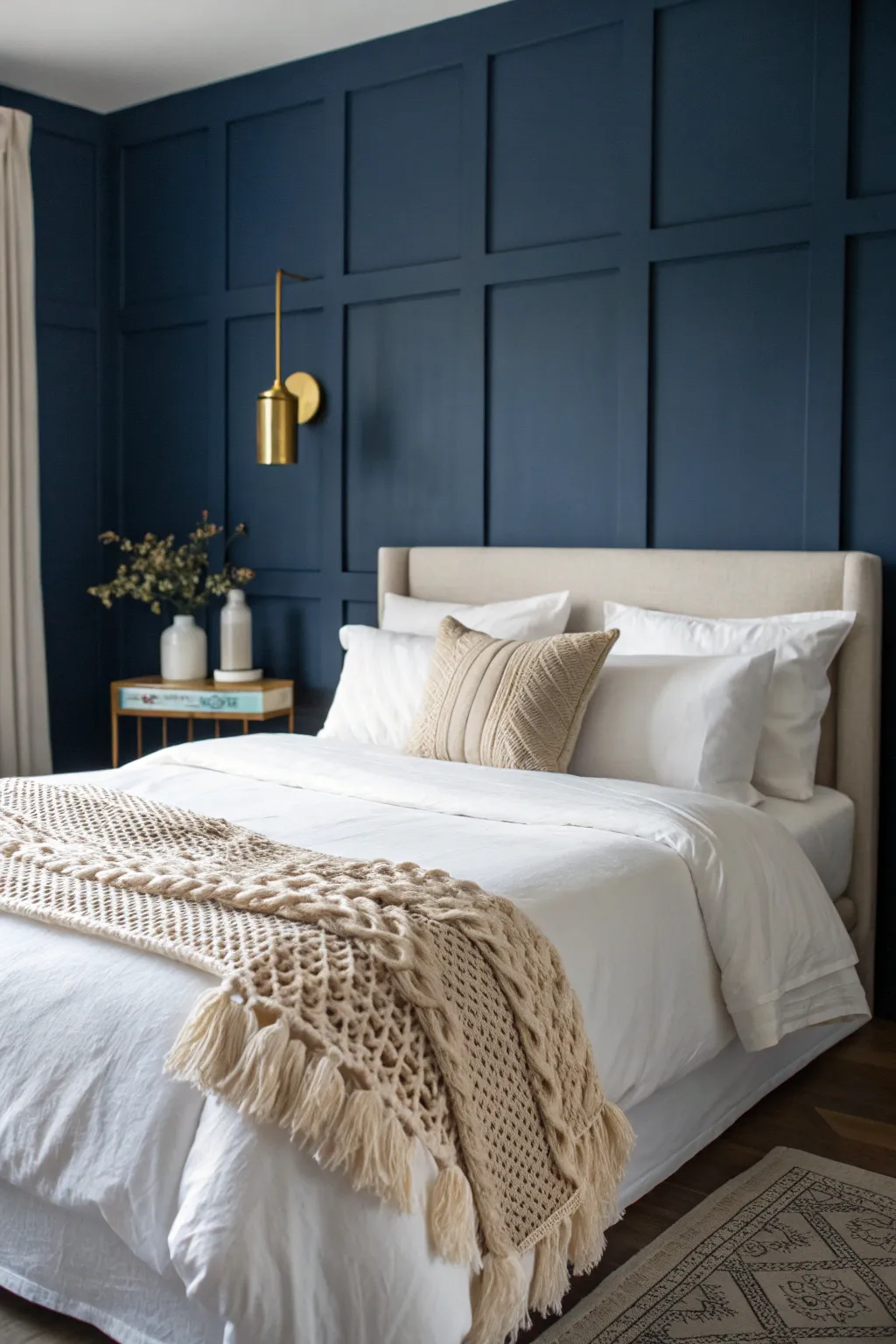 Deep navy walls meet crisp white linens for a moody, minimalist sanctuary.