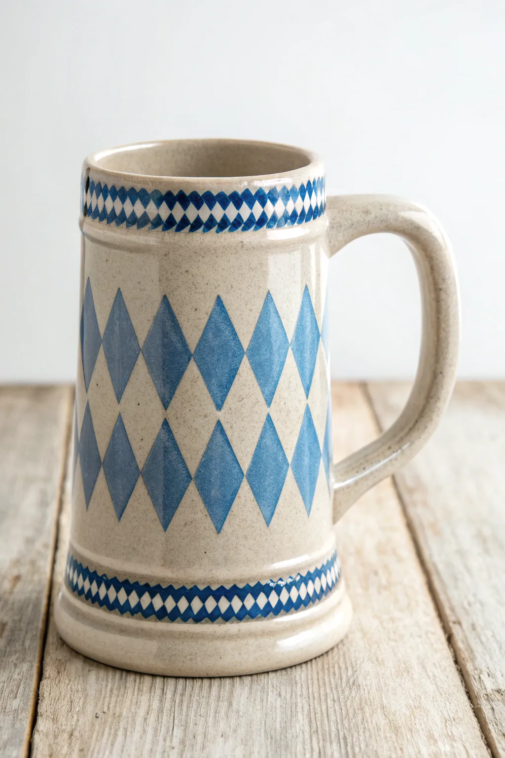Crisp Bavarian blue-and-white bands on a minimalist ceramic beer mug for clean festival vibes.