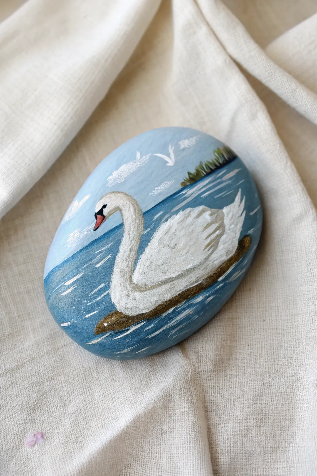 Calm swan scene on a flat painted stone, soft blues and white for minimalist boho charm