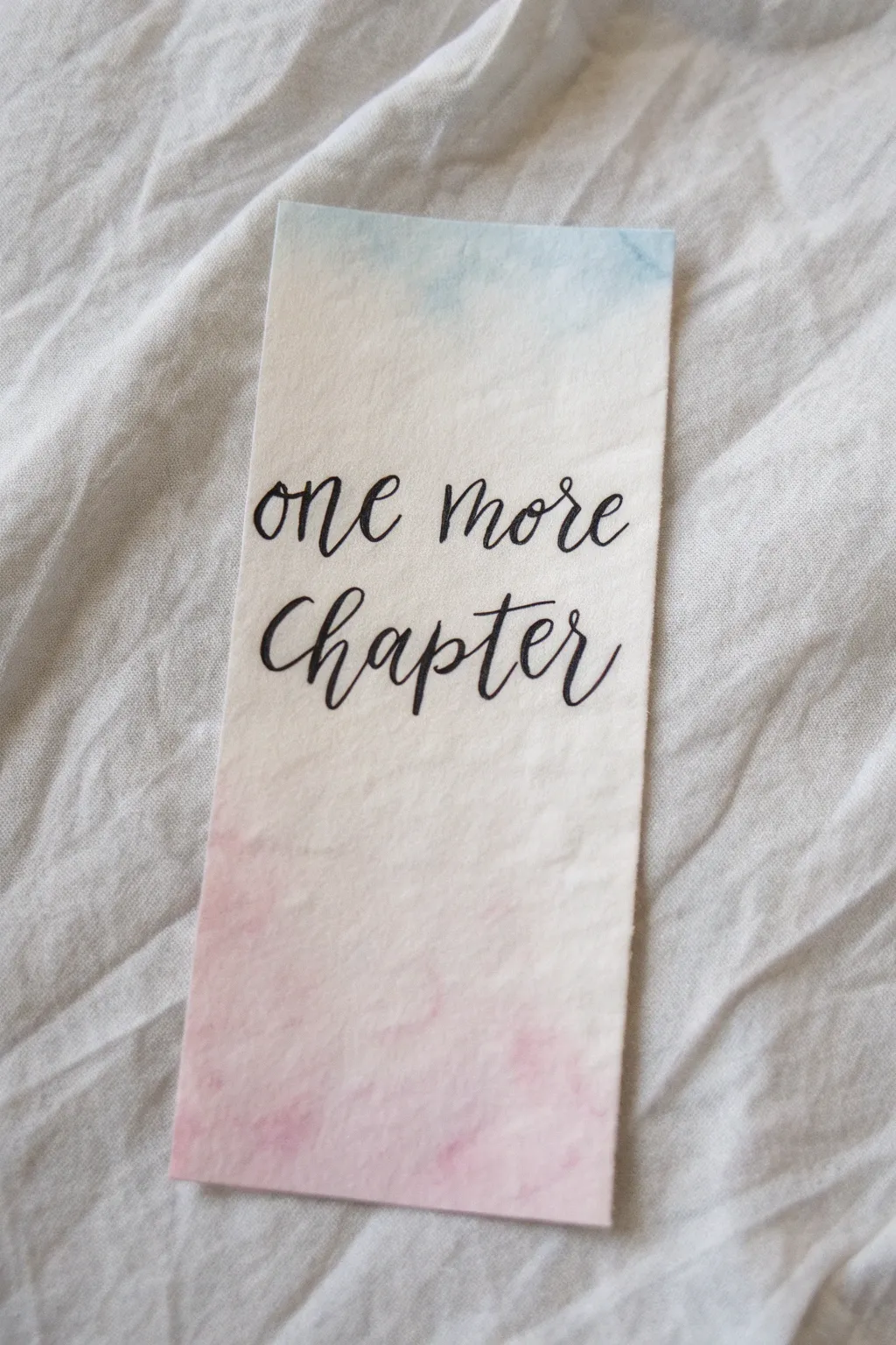 A simple yet stunning hand-lettered watercolor bookmark to mark your place in style.