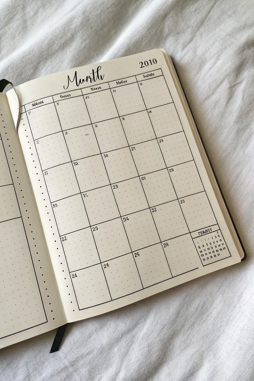 Minimal bullet journal calendar doodle with a tucked-in mini next-month grid in the margin