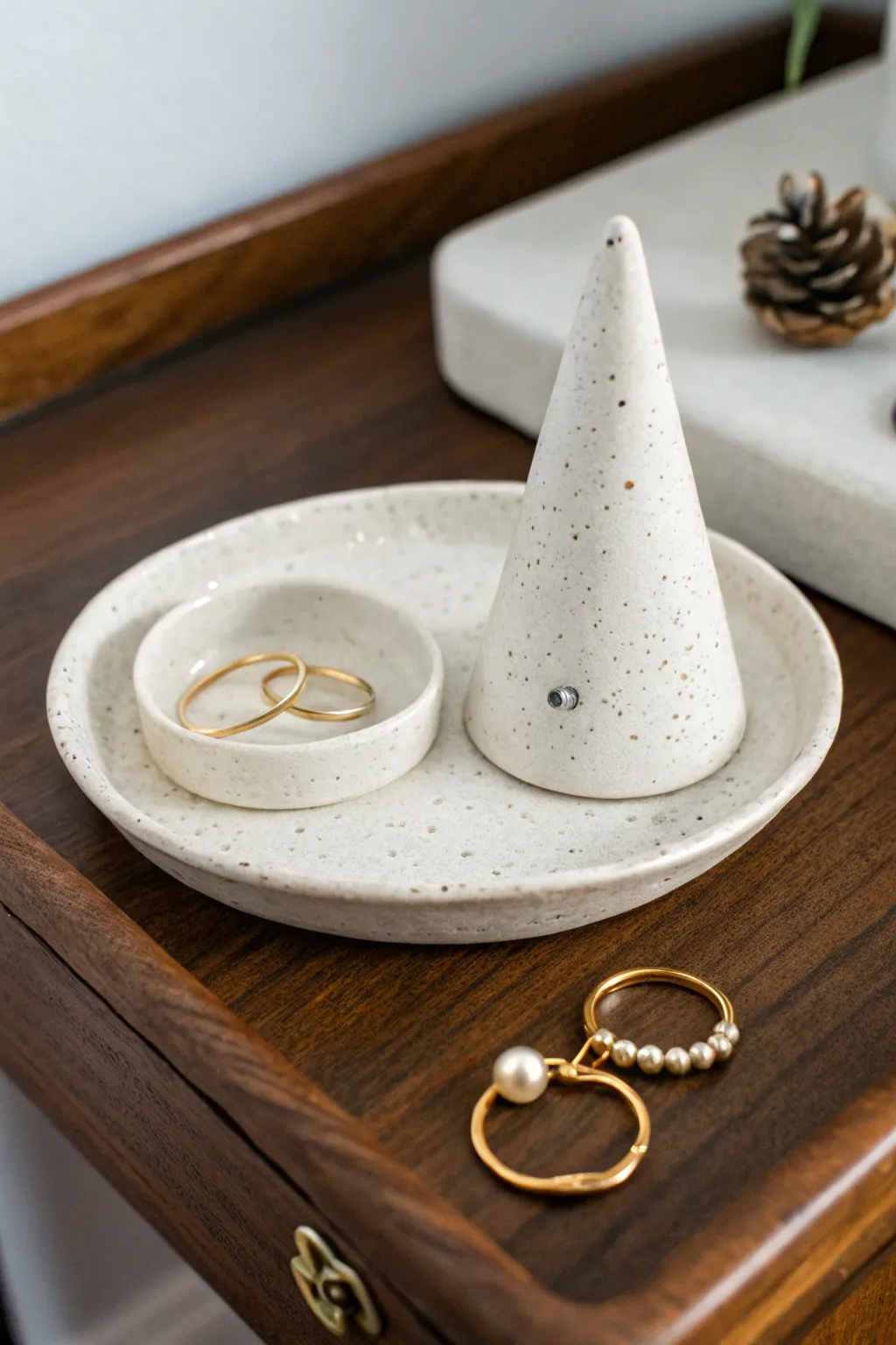 Minimal ceramic trinket dish and ring cone, softly styled for bedside jewelry storage.