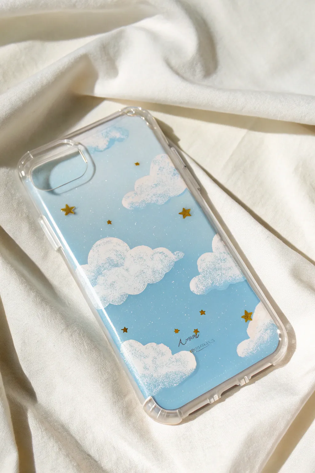 Soft cloud strokes and tiny star dots on a clear case, letting your phone color shine through.