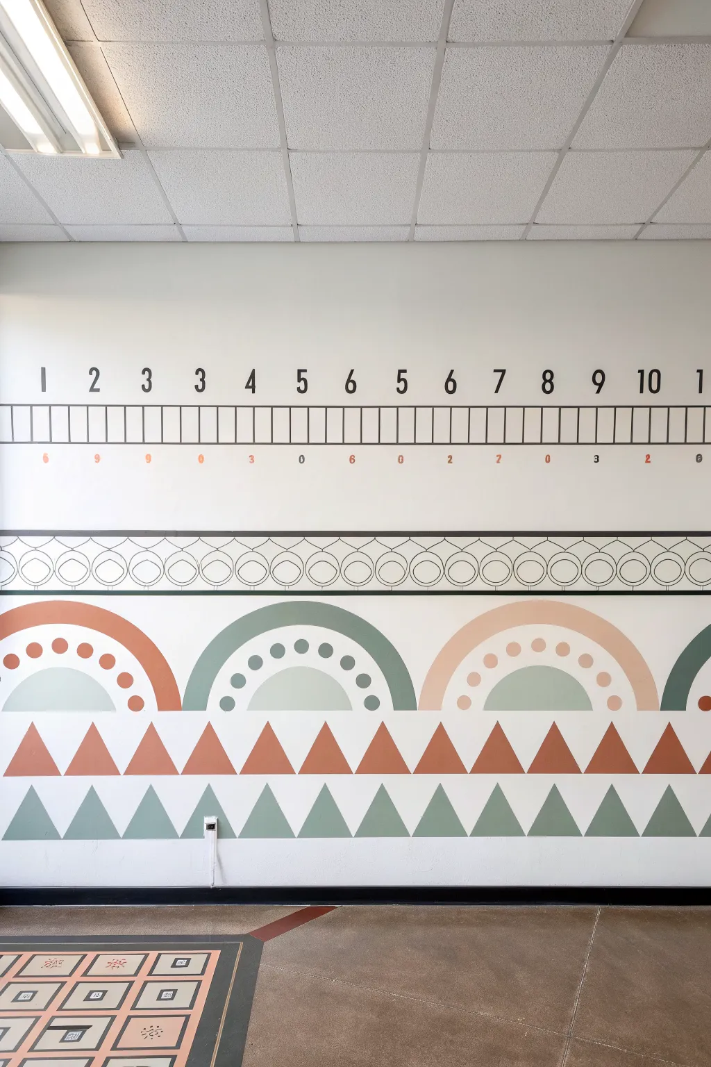 Minimalist number line mural with repeating shapes for a tidy, boho-Scandi classroom wall.