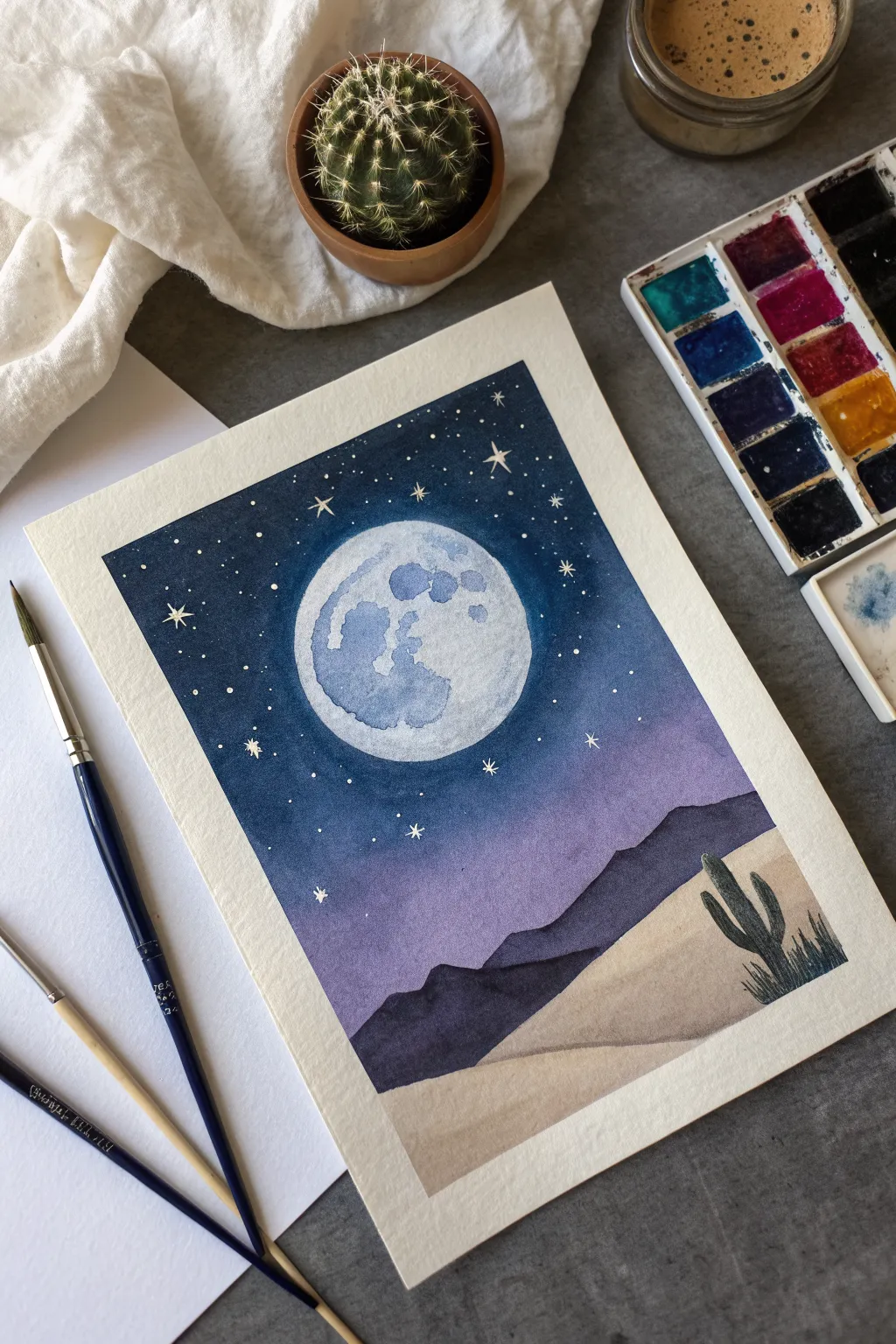 Easy desert night painting idea: glowing full moon over calm dunes and a lone cactus silhouette.
