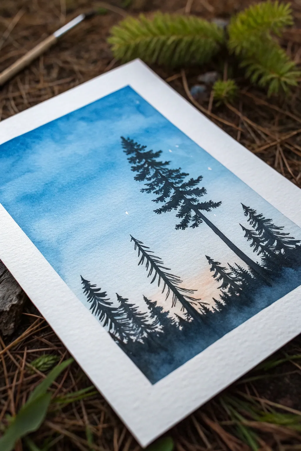 Easy blue painting idea: black pine silhouettes on a twilight wash for a calm minimalist look.