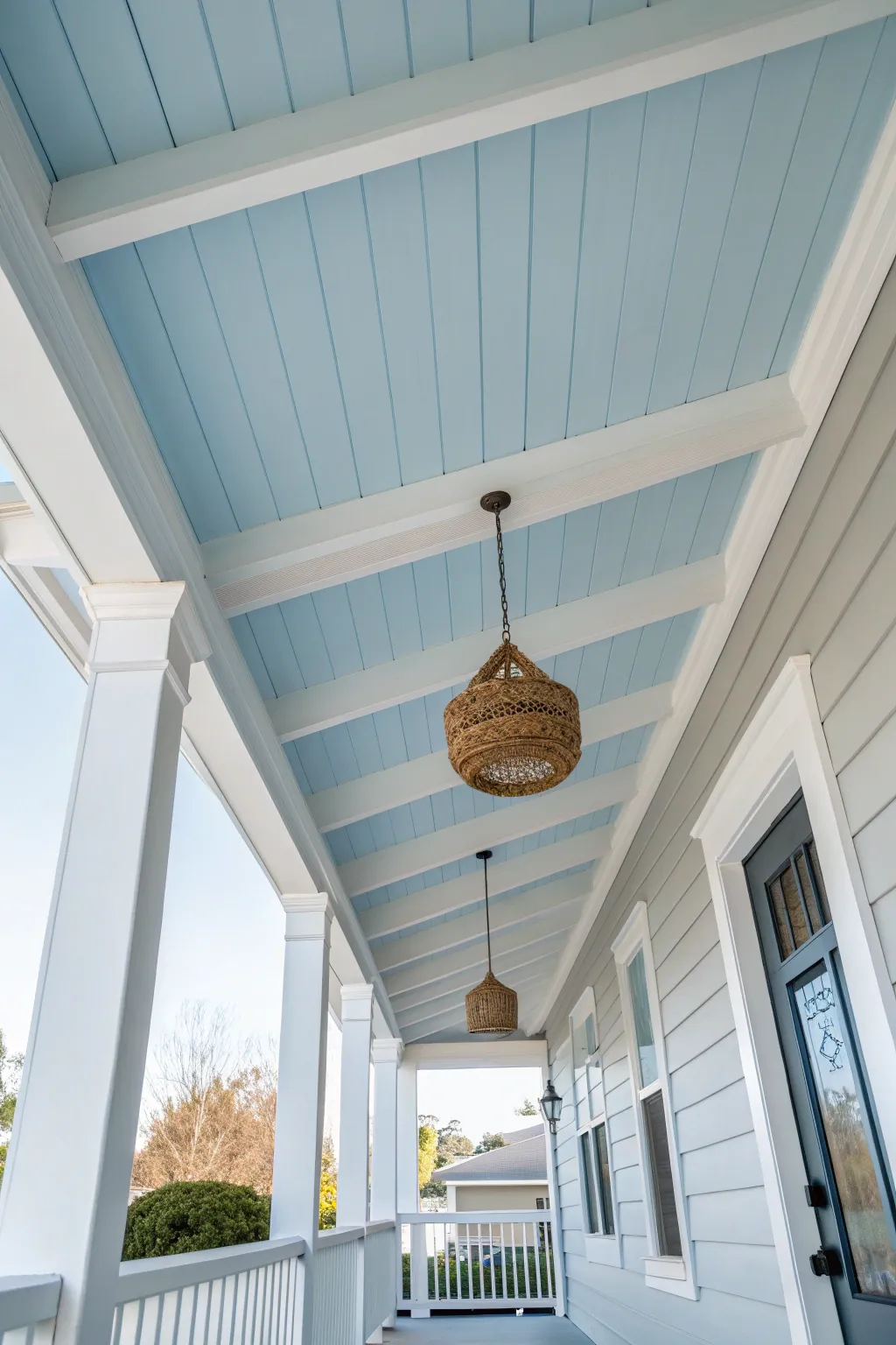 Soft sky blue porch ceiling with crisp white beams for a bright, airy, minimalist welcome