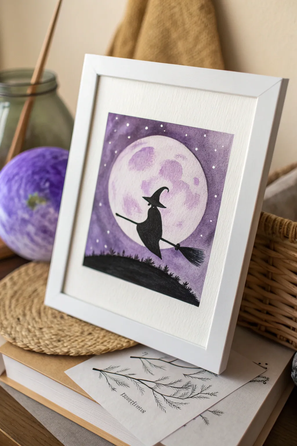 Minimal witch hat and broom silhouette on a glowing moon, an easy high-contrast Halloween paint idea