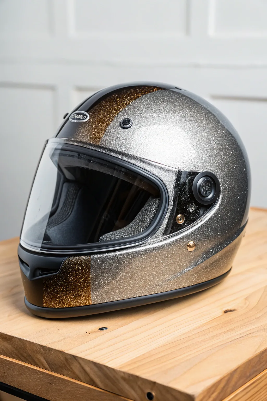 Metallic flake fade helmet finish, from deep charcoal to champagne sparkle in clean studio light