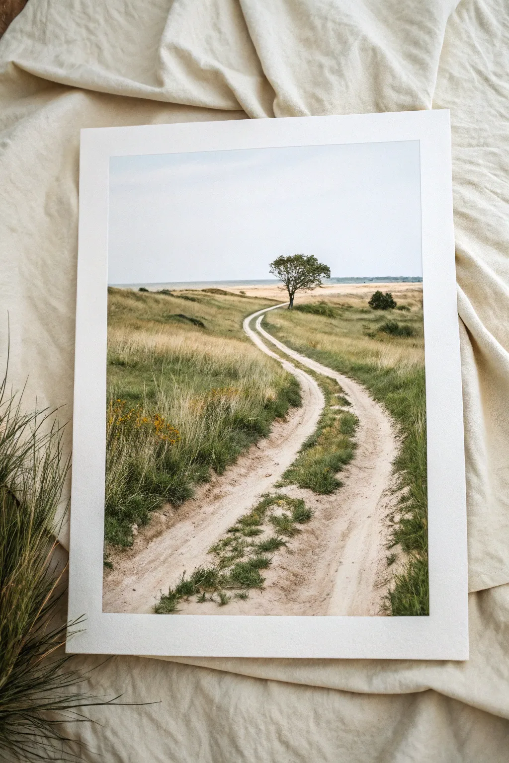 Meadow path leading lines in a minimalist watercolor, guiding the eye to a lone horizon tree.