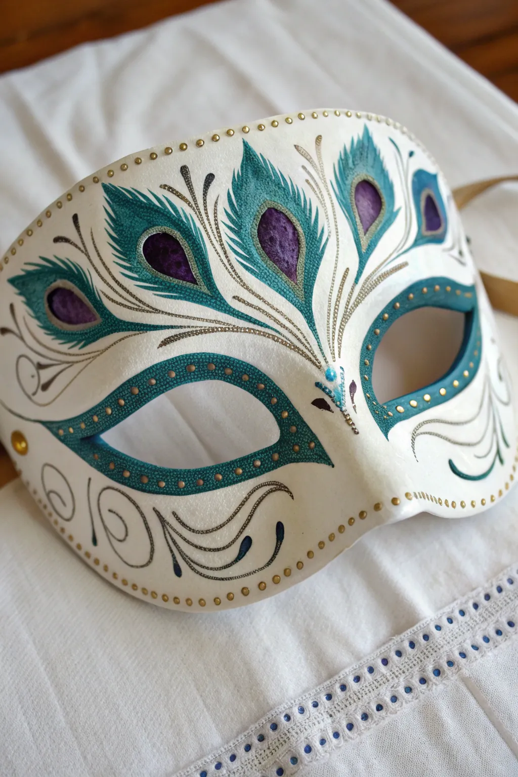 Peacock eye frame mask in jewel tones and fine gold lines, minimal boho elegance