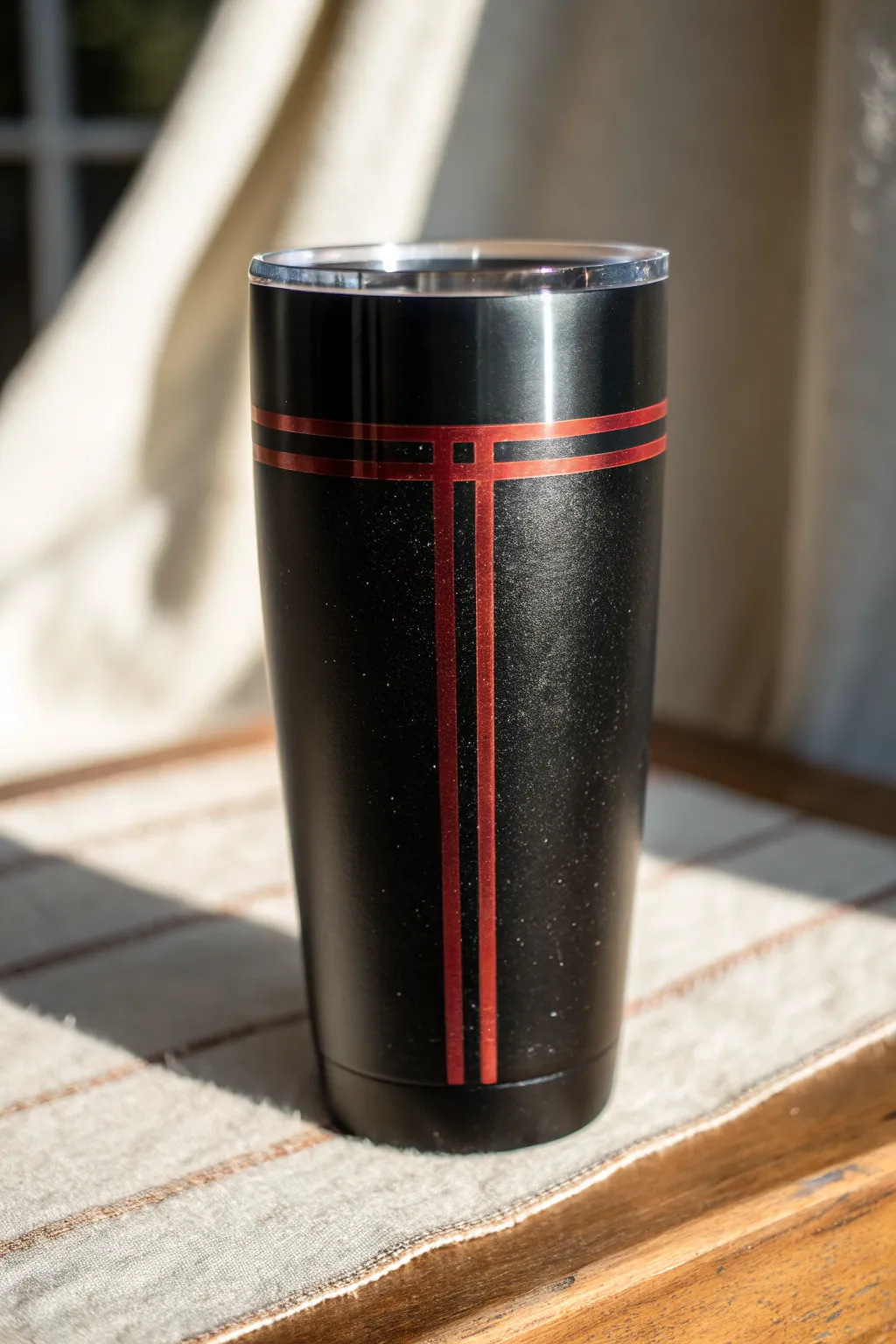 Minimalist black epoxy tumbler with a bold tribute line and distressed badge stripe detail