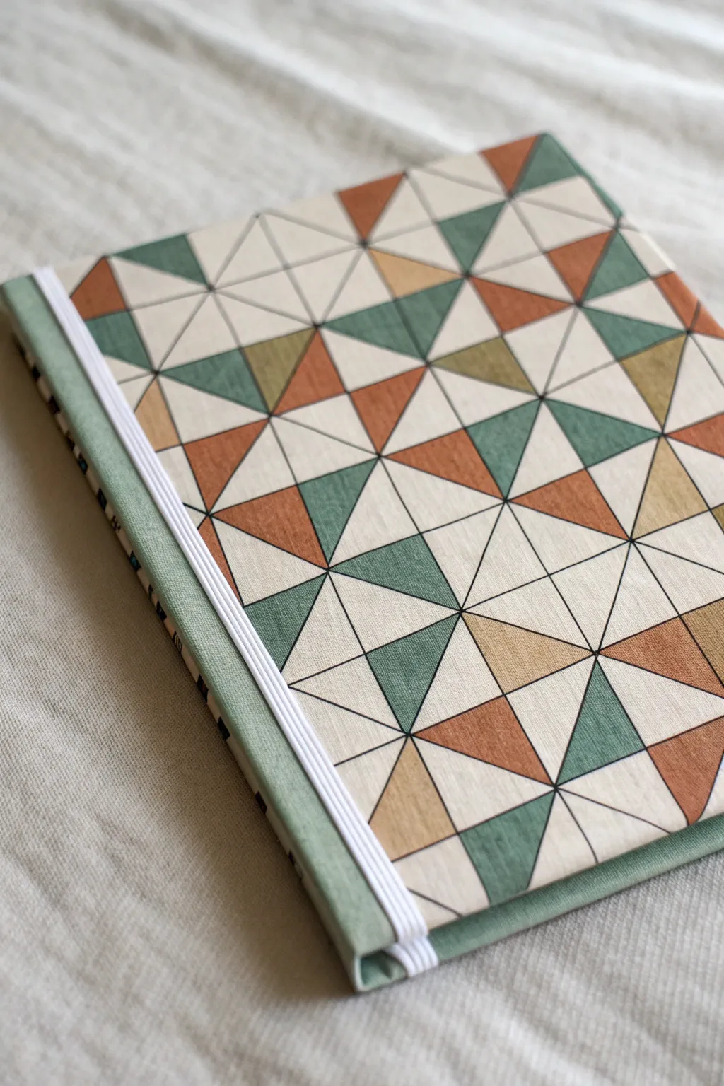 Geometric pattern fill for a notebook cover: simple triangles, clean lines, muted boho tones.