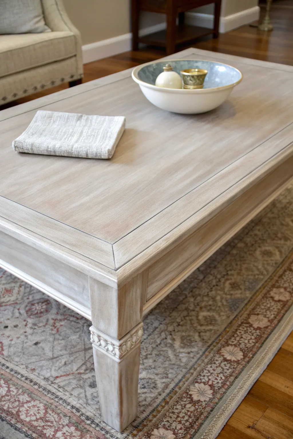 Soft greige paint wash coffee table with satin finish, linen textures, and natural neutral styling