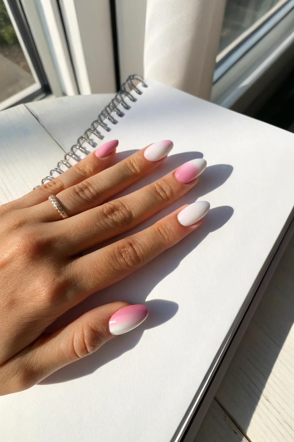 Soft pink-to-white ombre nails on a blank sketchbook page, minimalist Scandinavian calm with boho warmth