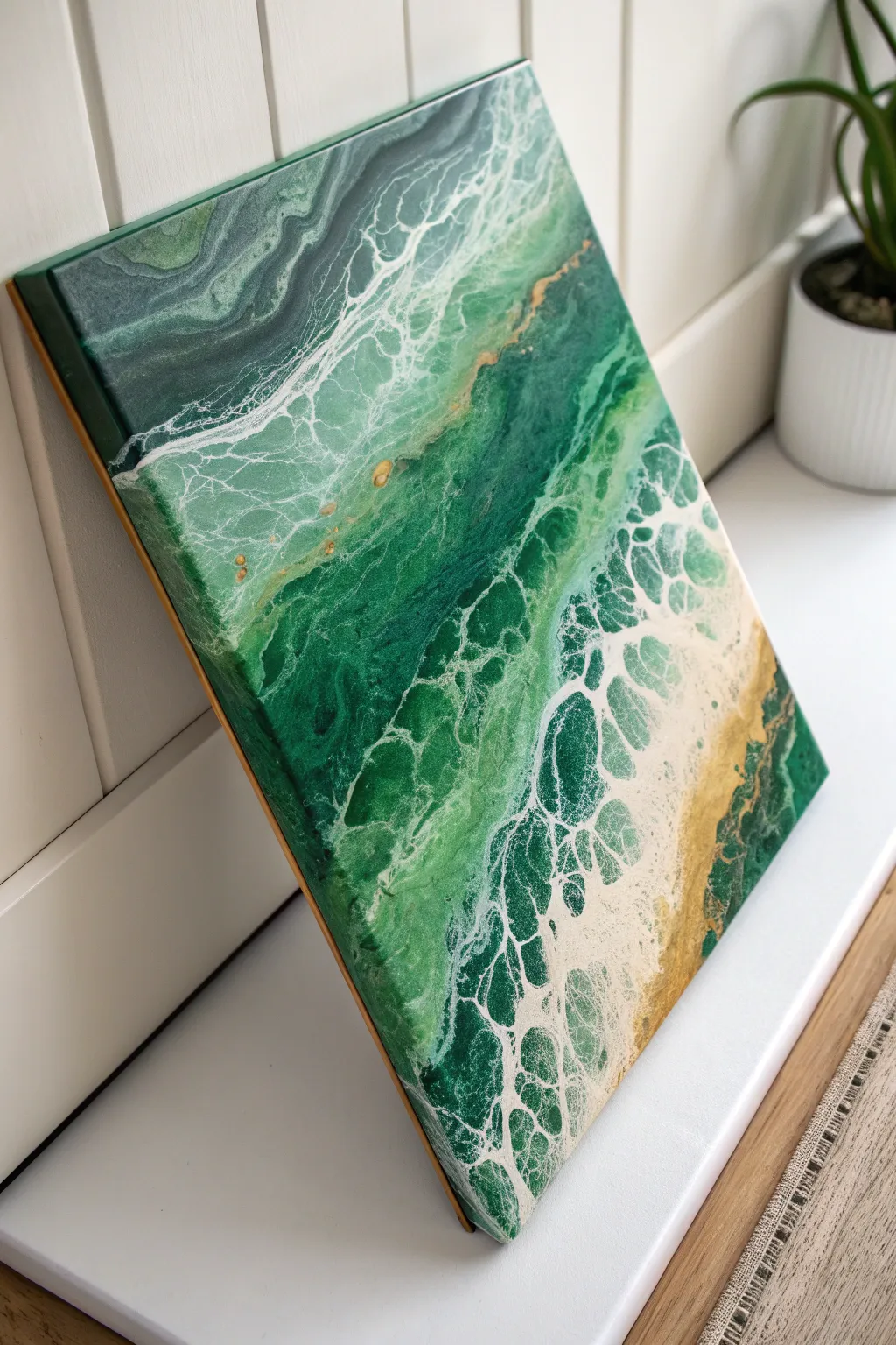 Emerald green pour painting softened with creamy neutrals and a swipe line of delicate cells